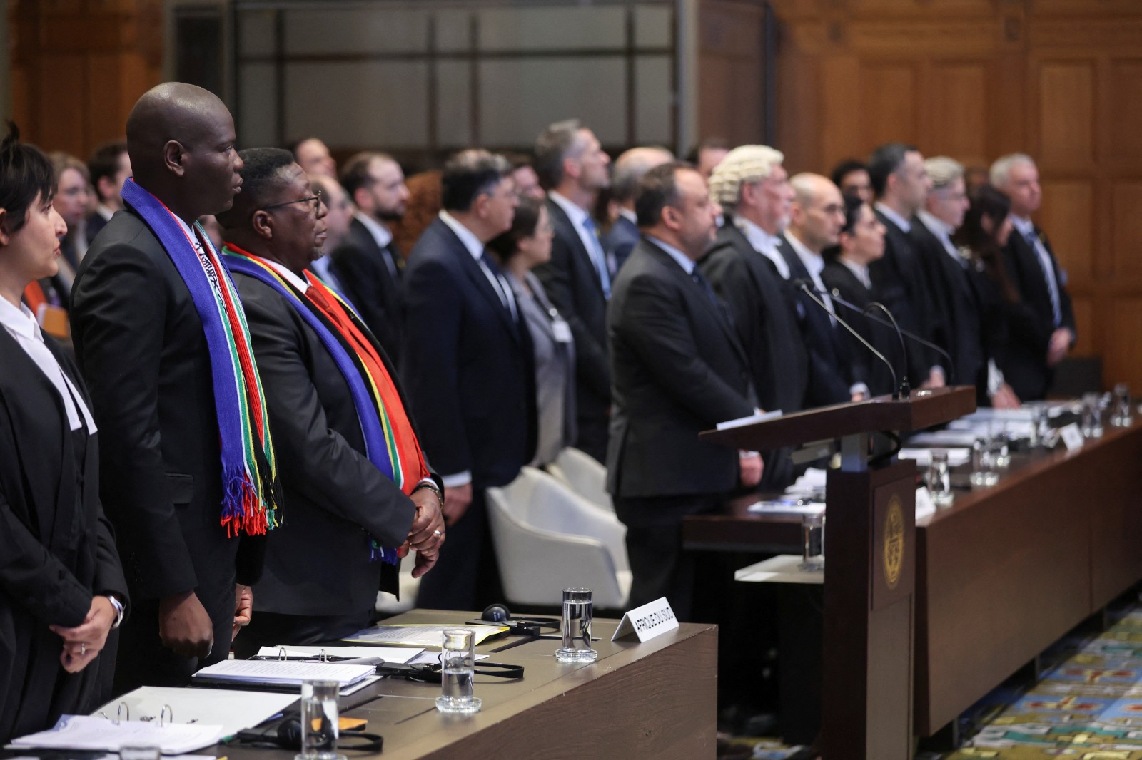 South Africa's Minister of Justice Ronald Lamola and the delegation stand as judges at the International Court of Justice (ICJ) hear a request for emergency measures by South Africa, who asked the court to order Israel to stop its military actions in Gaza and to desist from what South Africa says are genocidal acts committed against Palestinians during the war with Hamas in Gaza, in The Hague, Netherlands, January 11, 2024. REUTERS/Thilo Schmuelgen