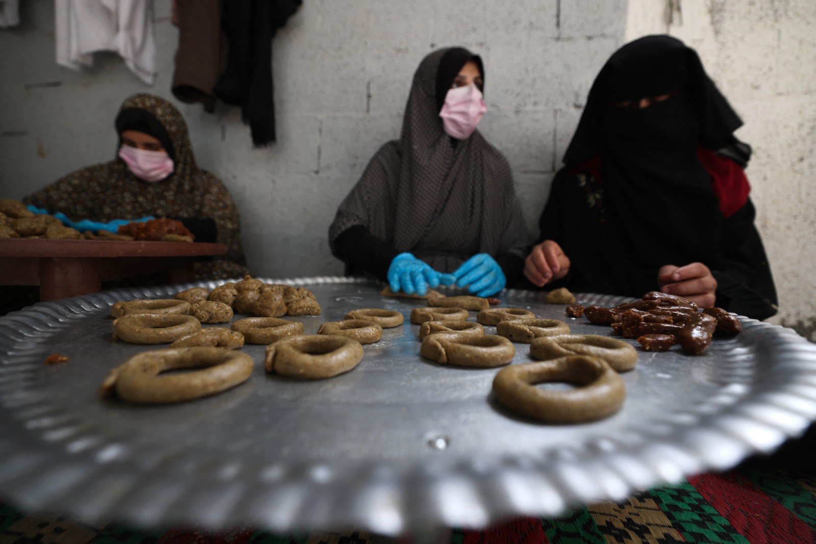 نساء فلسطينيات متطوعات في مبادرة خيرية لإعداد الكعك التقليدي في رفح بجنوب قطاع غزة. 8 أبريل 2024