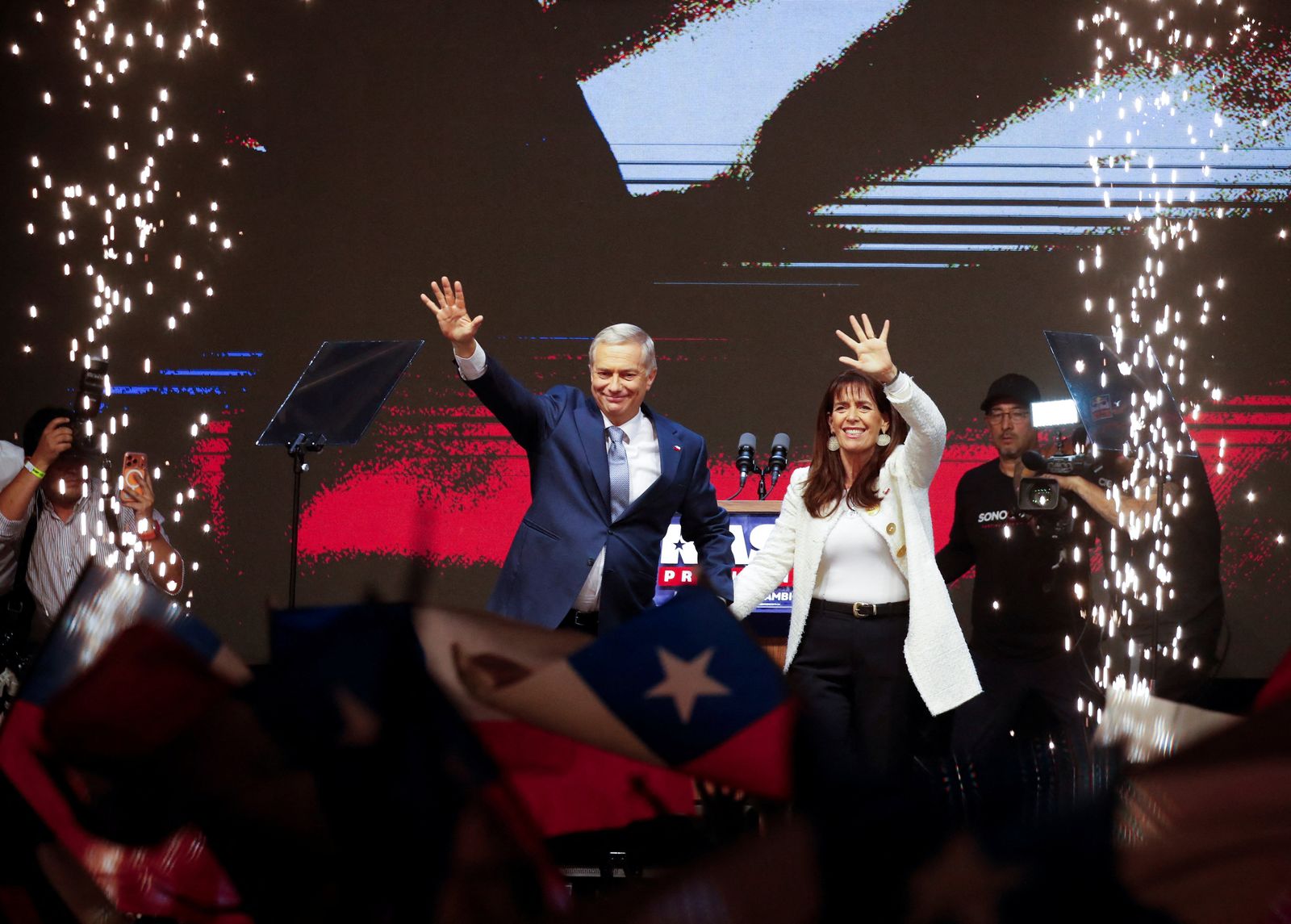 Jose Antonio Kast, presidential candidate of the far-right Republican Party of Chile and his wife Maria Pia Adriasola wave to their supporters as they celebrate after Kast won Chile's presidency in a presidential runoff election, in Santiago, Chile, December 14, 2025. REUTERS/Rodrigo Garrido