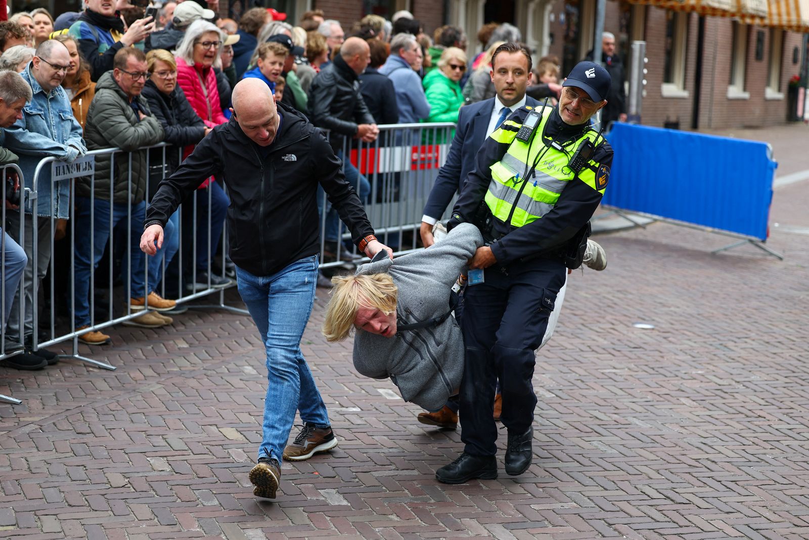 Security personnel detain a Pro-Palestinian protester, on the day of a liberation parade, where they commemorate the victims of war and celebrate freedom, in Wageningen, Netherlands, May 5, 2025. REUTERS/Piroschka van de Wouw