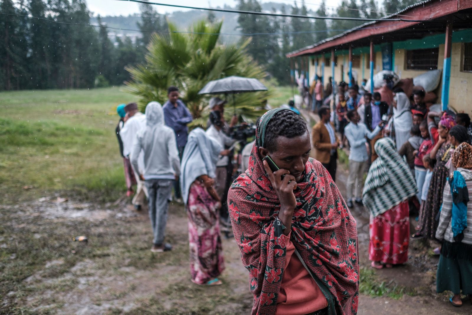 An internally displaced man from Amhara Region talks on the phone at the Addis Fana School where he is temporary sheltered, in the city of Dessie, Ethiopia, on August 23, 2021. - Long confined to Tigray, the conflict in Ethiopia has recently spread to two neighbouring regions, Afar and Amhara, with heavy weapons fire killing an untold number of civilians and displacing hundreds of thousands more. (Photo by EDUARDO SOTERAS / AFP) - AFP