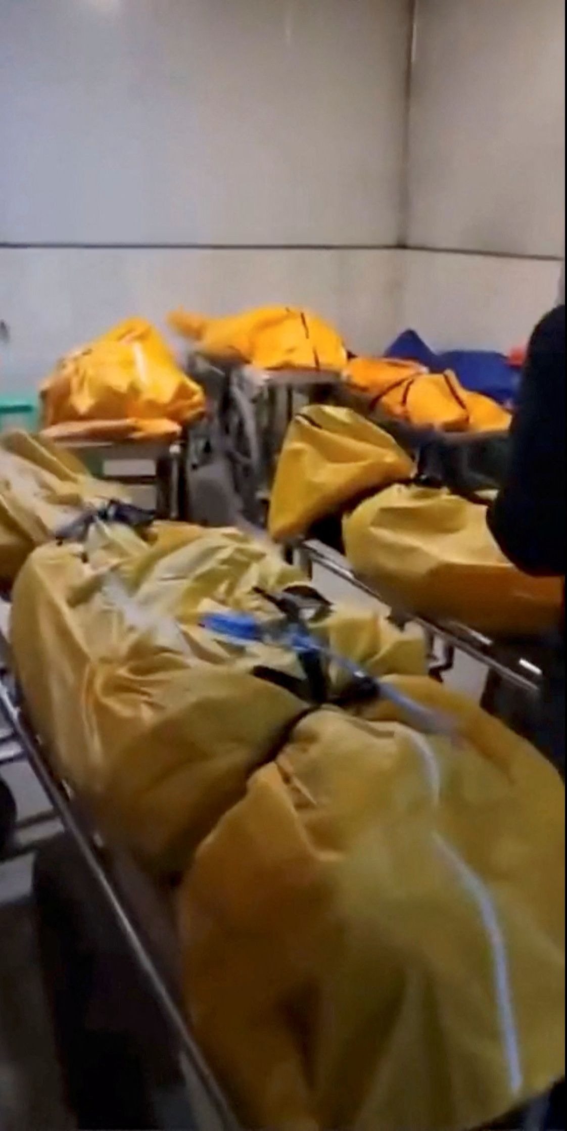 Several body bags are lined up around the level at a loading bay in a building, amid the coronavirus disease (COVID-19) outbreak, in Chongqing - via REUTERS