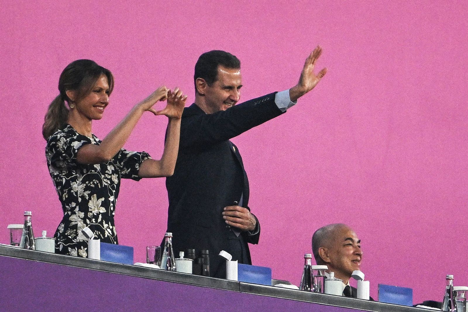 Syria's President Bashar al-Assad (C) and his wife Asma al-Assad (L) attend the opening ceremony of the 2022 Asian Games at the Hangzhou Olympic Sports Centre Stadium in Hangzhou in China's eastern Zhejiang province on September 23, 2023. (Photo by Philip FONG / AFP)