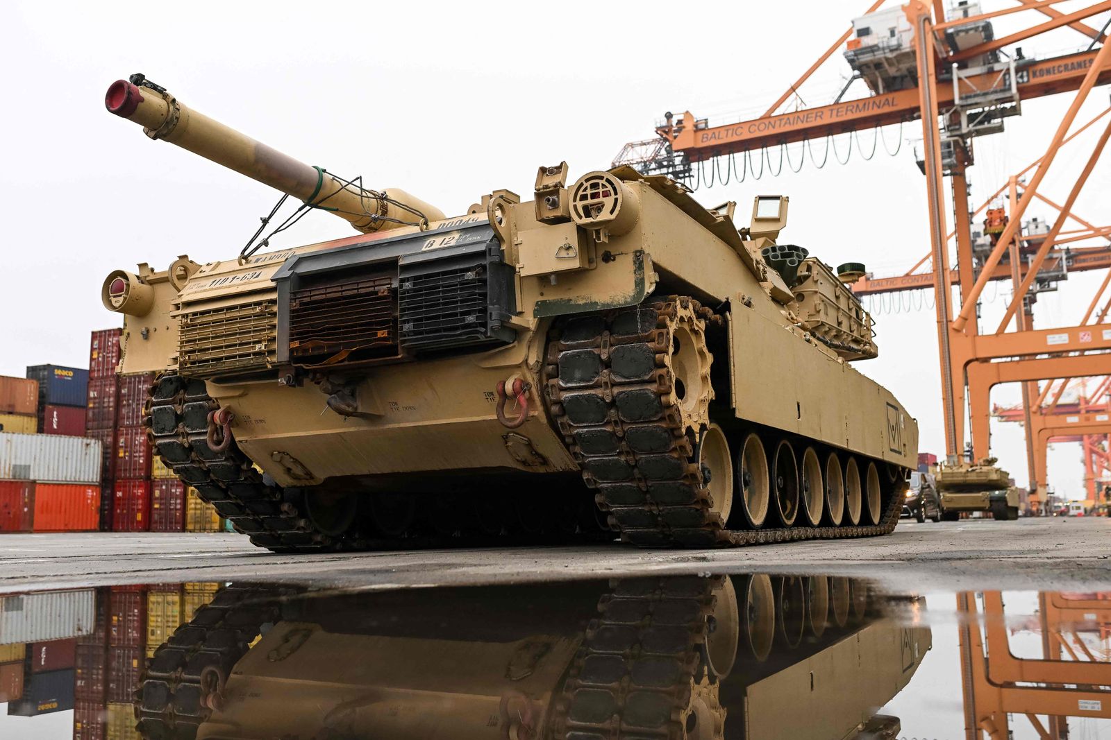(FILES) In this file photo taken on December 3, 2022, an M1A2 Abrams battle tank of the US army that will be used for military exercises by the 2nd Armored Brigade Combat Team, is unloaded at the Baltic Container Terminal in Gdynia, Poland. - US President Joe Biden announced on January 25, 2023, the US will send 31 Abrams tanks to Ukraine. (Photo by MATEUSZ SLODKOWSKI / AFP)