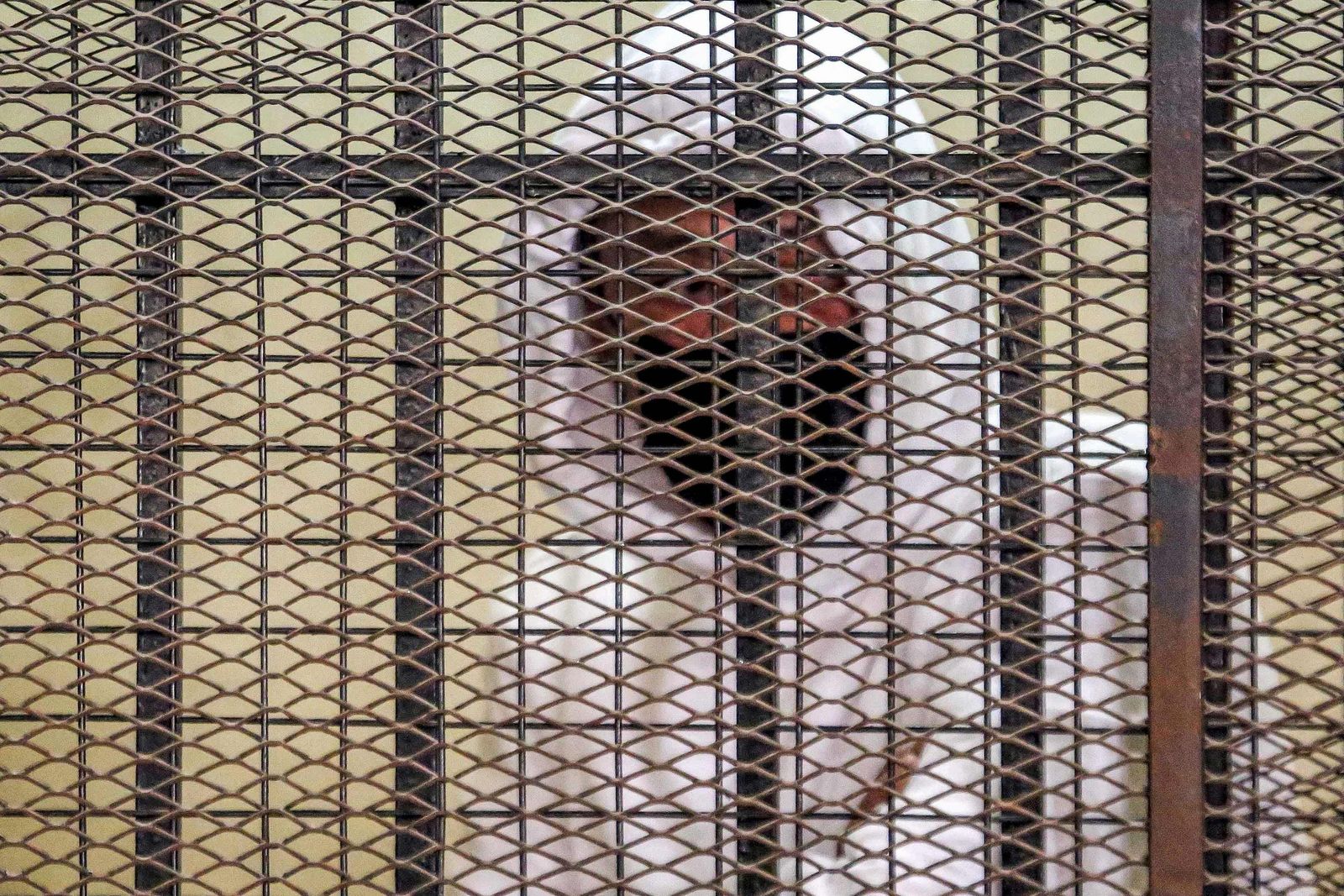 (FILES) In this file photo taken on March 20, 2022 Egyptian media and real estate tycoon Mohamed el-Amin looks from the defendant's cage during a trial session over charges of 