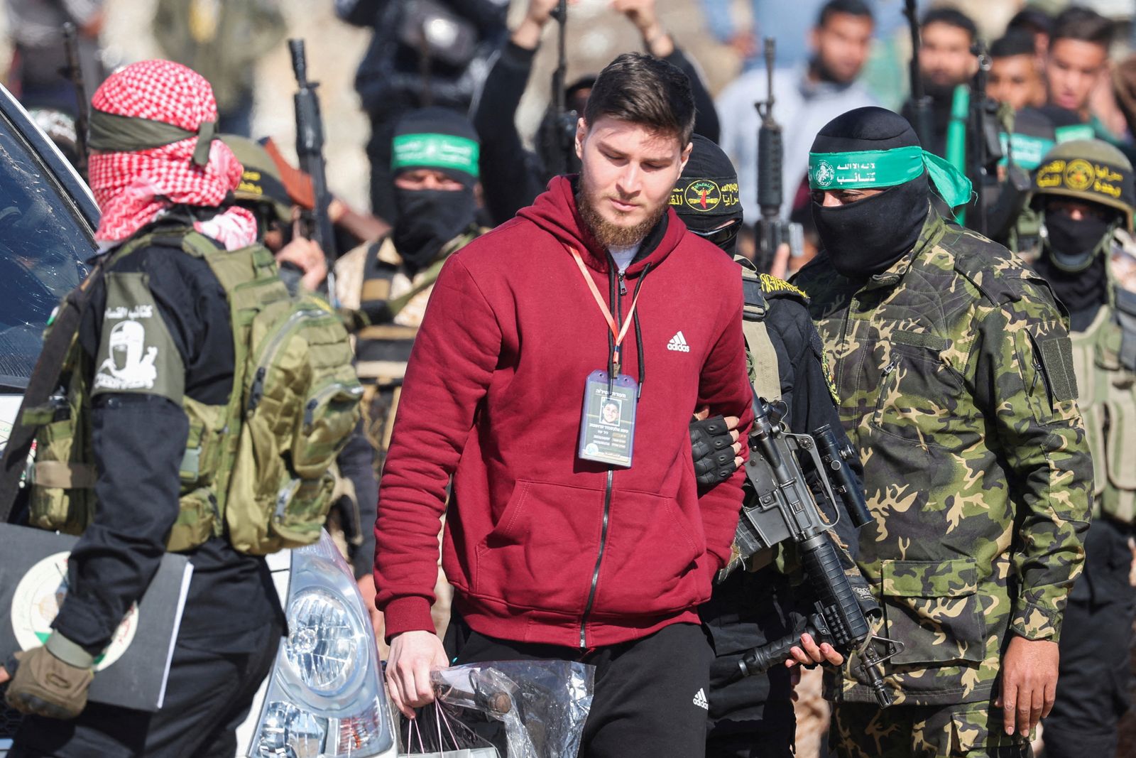 Russian-Israeli Sasha (Alexander) Troufanov, a hostage held in Gaza since the deadly October 7, 2023 attack, is escorted by Palestinian Hamas militants and Islamic Jihad militants as part of a ceasefire and a hostages-prisoners swap deal between Hamas and Israel in Khan Younis, in the southern Gaza Strip, February 15, 2025. REUTERS/Ramadan Abed REFILE - QUALITY REPEAT     TPX IMAGES OF THE DAY