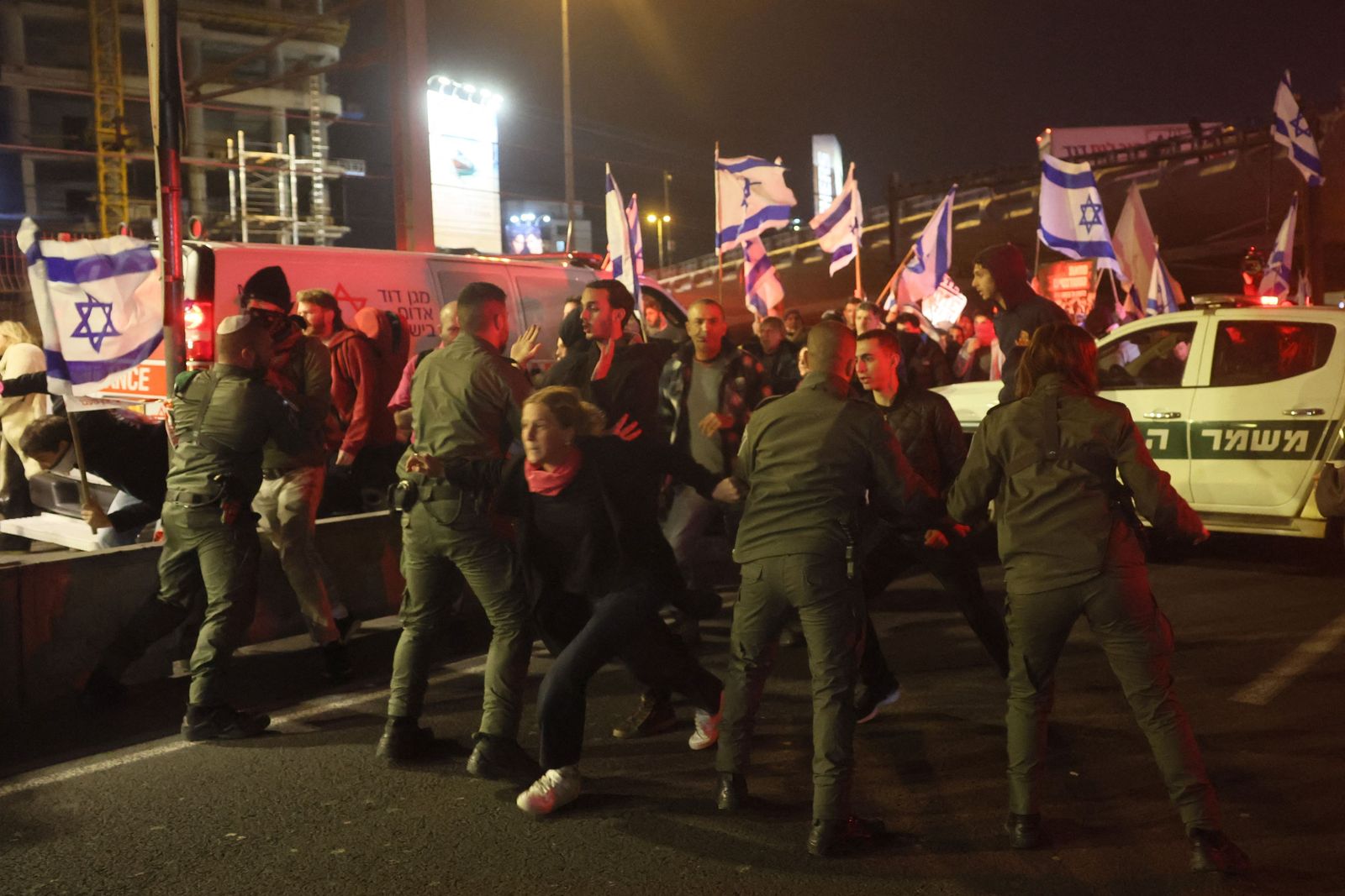 Israeli police block the road in front of protesters during a rally in central Tel Aviv, on February 11, 2023, against controversial legal reforms being touted by the country's hard-right government. (Photo by JACK GUEZ / AFP) - AFP