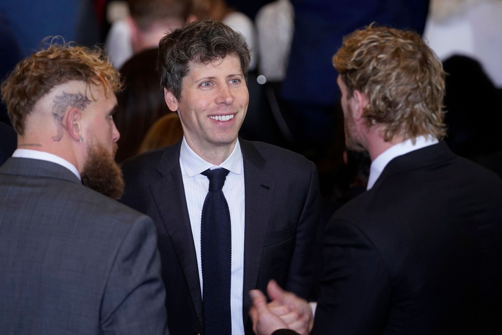 Sam Altman, chief executive officer of OpenAI Inc., center, with boxer Jake Paul and wrestler Logan Paul during the 60th presidential inauguration in Emancipation Hall of the US Capitol in Washington, DC, US, on Monday, Jan. 20, 2025. Donald Trump's Monday swearing-in marks just the second time in US history that a president lost the office and managed to return to power - a comeback cementing his place within the Republican Party as an enduring, transformational figure rather than a one-term aberration. Photographer: Al Drago/Bloomberg