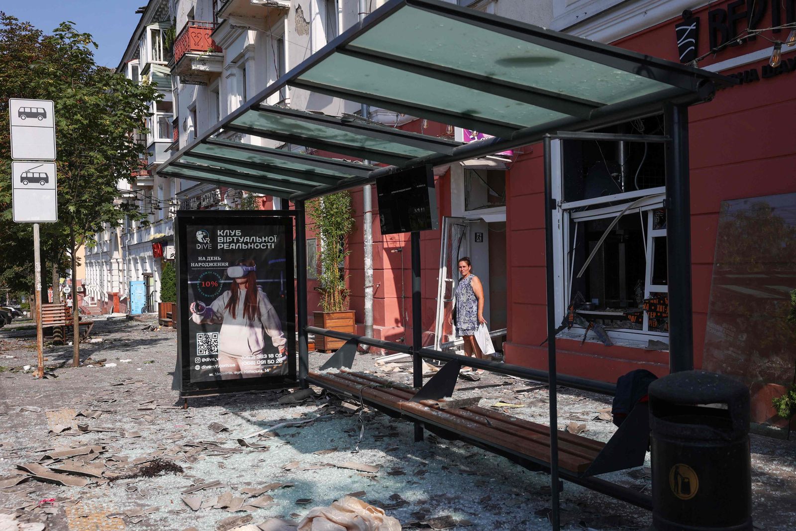 TOPSHOT - A local resident stands amid the debris and shattered glass of windows following a missile strike in Chernihiv, on August 19, 2023. (Photo by Anatolii STEPANOV / AFP) - AFP