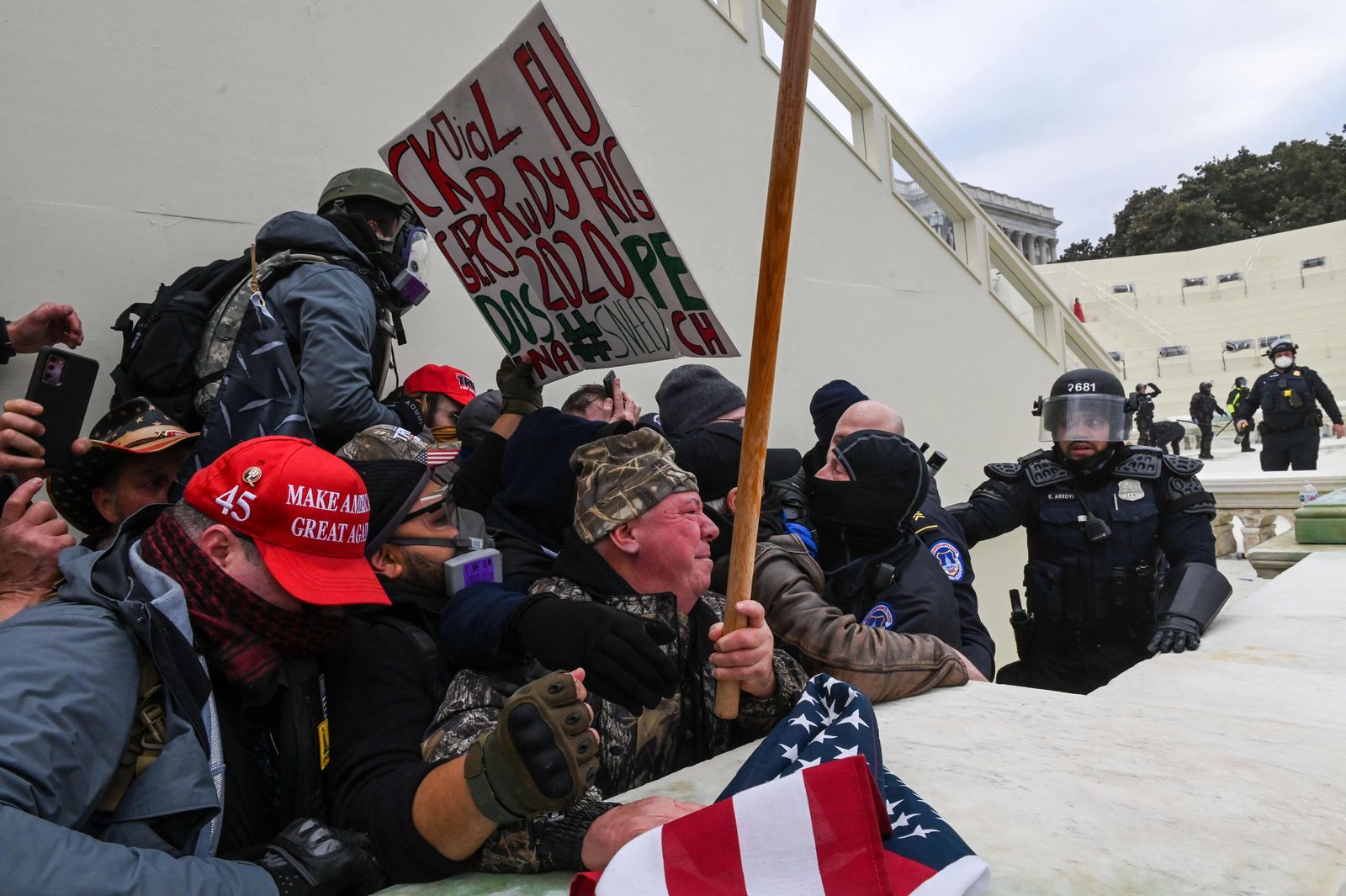 (FILES) In this file photo taken on January 6, 2021 Trump supporters clash with police and security forces as they invade the Inauguration platform of the US Capitol in Washington, DC. - When Donald Trump looks down for the last time from his helicopter over the White House lawn on January 20, 2021, the wreckage of his presidency will be inescapable. The showman with the dyed blond hair, fake tan and a knack for connecting with crowds took office four years ago, making the startling promise in his inaugural speech that he would end 
