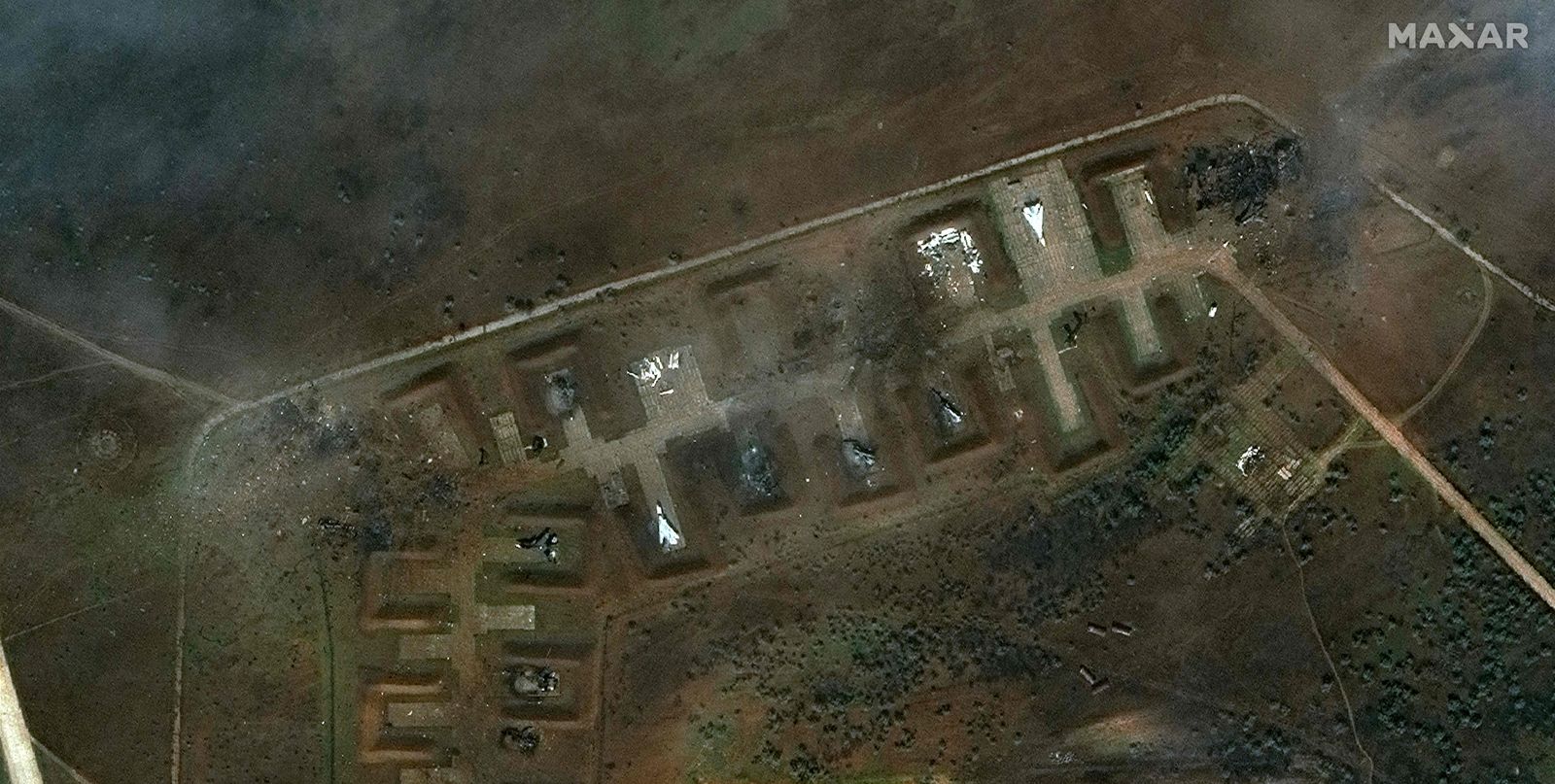 This handout satellite image courtesy of Maxar Technologies released on August 11, 2022 shows the aftermath of the reported attack on the Saki airbase at Novofedorivka, Crimea. - Moscow insisted that major blasts at a key military airbase on the Russian-annexed Crimea peninsula were caused by exploding ammunition rather than Ukrainian fire. (Photo by Satellite image �2022 Maxar Technologies / AFP) / RESTRICTED TO EDITORIAL USE - MANDATORY CREDIT 