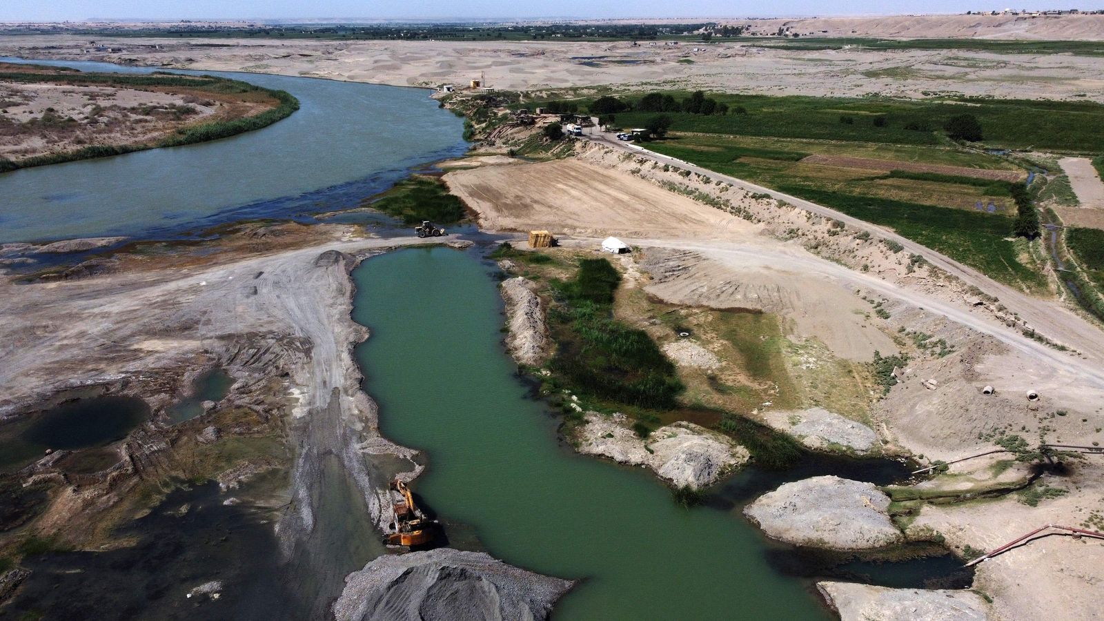 This aerial view shows a portion of the Euphrates River on September 17, 2022, a major source of contaminated water used for both drinking and irrigation, near the town of Al-Kasrah, in Syria's eastern Deir Ezzor province. - Cholera is making its first major comeback since 2009 in Syria, where nearly two thirds of water treatment plants, half of pumping stations and one third of water towers have been damaged by more than a decade of war, according to the United Nations. (Photo by Delil SOULEIMAN / AFP) - AFP