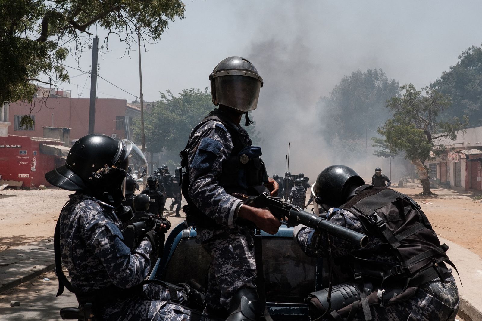 Police fire tear gas from the back of a pickup truck at protesters in Dakar on June 1, 2023, during unrest following the sentence of opponent Ousmane Sonko. A court in Senegal on Thursday sentenced opposition leader Ousmane Sonko, a candidate in the 2024 presidential election, to two years in prison on charges of 