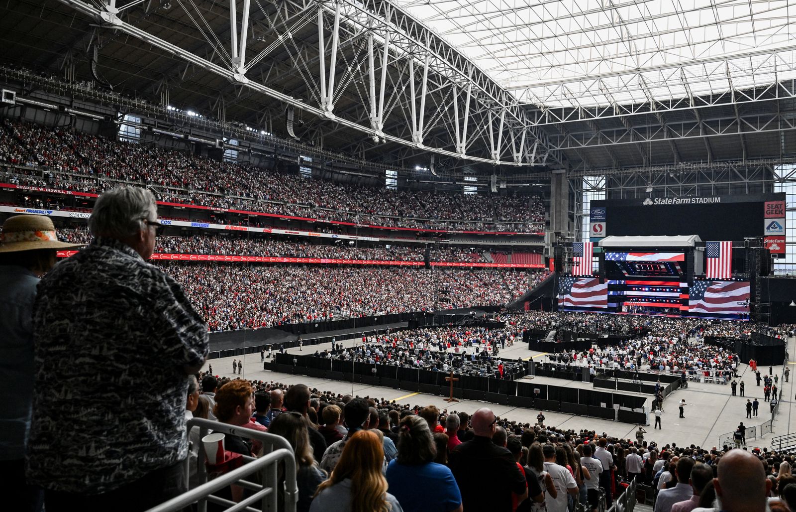 People listen to the national anthem during a memorial service for slain conservative commentator Charlie Kirk at State Farm Stadium in Glendale, Arizona, U.S., September 21, 2025. REUTERS/Caitlin O'Hara