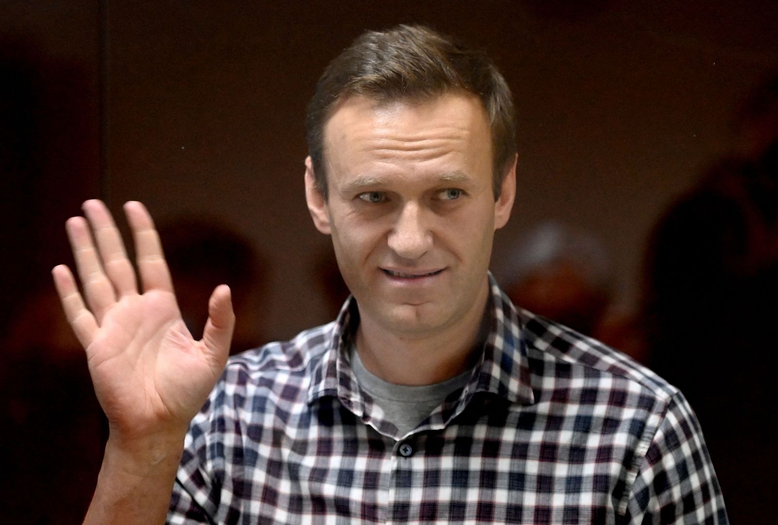 (FILES) In this file photograph taken on February 20, 2021, Russian opposition leader Alexei Navalny stands inside a glass cell during a court hearing at the Babushkinsky district court in Moscow. - Russia on January 25, 2022,  added jailed Kremlin critic Alexei Navalny to a list of 