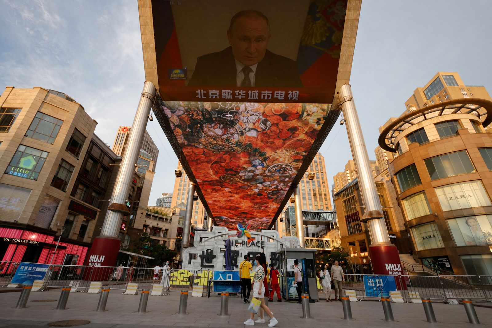 A screen shows a CCTV state media news broadcast of Russian President Vladimir Putin, addressing the BRICS Business Forum via video link, at a shopping center in Beijing - REUTERS