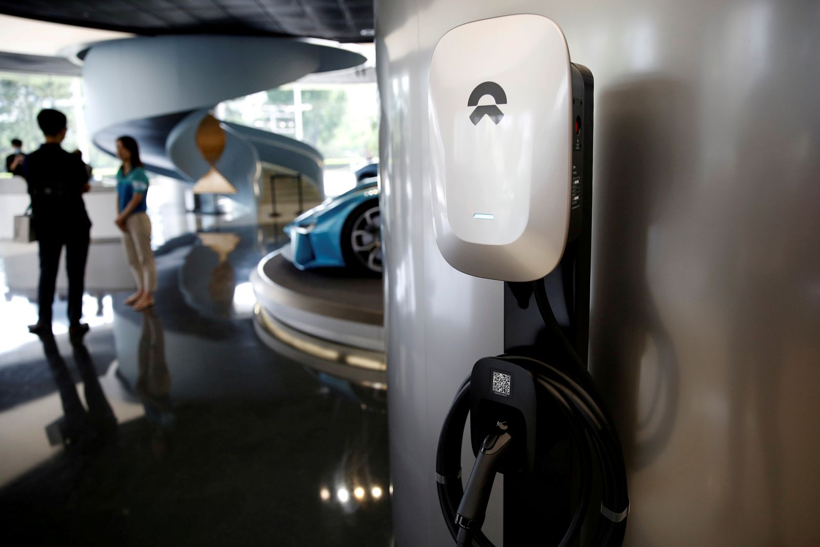 FILE PHOTO: NIO charging station is seen displayed at its store in Beijing - REUTERS