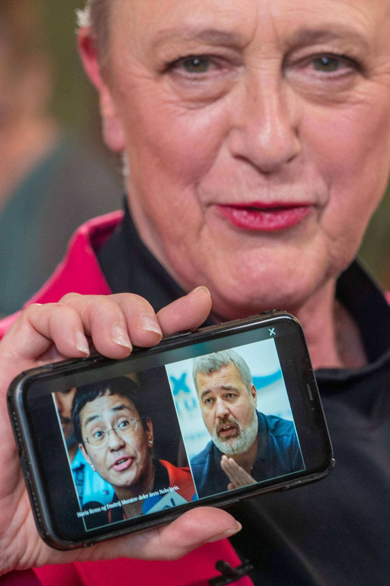 Berit Reiss-Andersen, chair of the Nobel Peace Prize Committee, presents a mobile phone displaying a combination of pictures of journalists Maria Ressa and Dmitry Muratov following a press conference to announce the winners of the 2021 Nobel Peace Prize at the Norwegian Nobel Institute in Oslo, on October 8, 2021. - The 2021 Nobel Peace Prize was awarded to journalists Maria Ressa of the Philippines and Dmitry Muratov of Russia for their fight for freedom of expression in their countries. The pair were honoured 