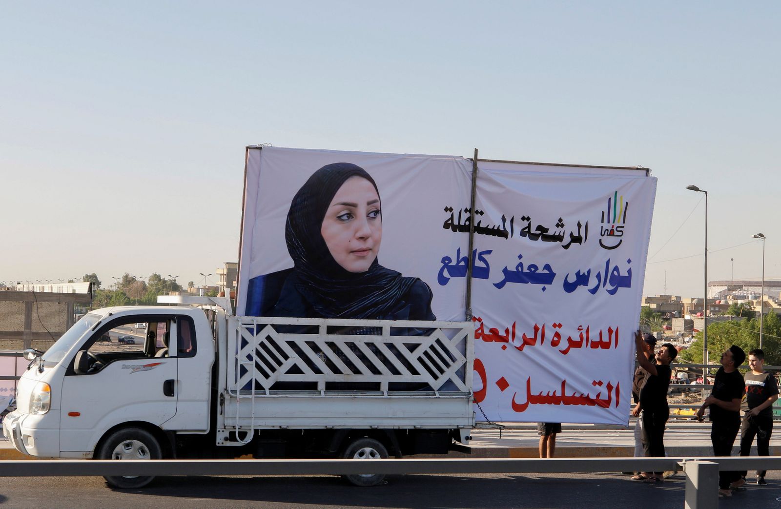 سيارة تحمل لوحة إعلانية لإحدى المرشحات للانتخابات العراقية التشريعية في بغداد- 27 سبتمبر 2021 - REUTERS