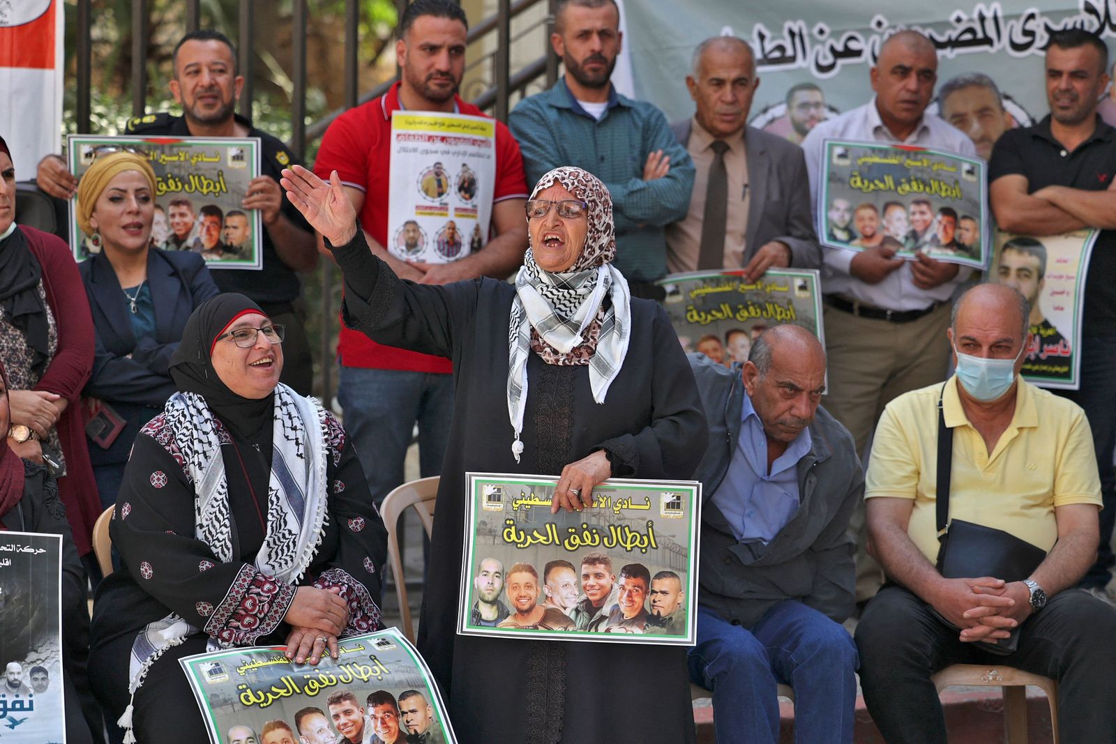 A protester chants slogans as people gather with signs for a demonstration in support of Palestinian prisoners held in Israeli prisons, outside the offices of the International Committee of the Red Cross (ICRC) in Ramallah in the occupied West Bank on September 14, 2021. (Photo by ABBAS MOMANI / AFP) - AFP