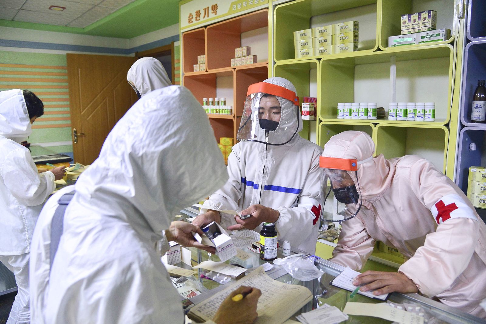 Members of North Korean army supply medicines to residents at pharmacy amid fears over COVID-19, in Pyongyang - via REUTERS