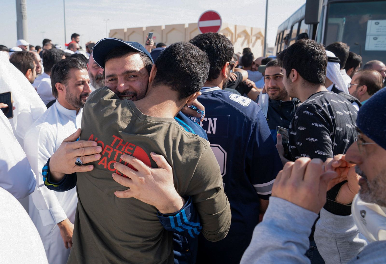 Kuwaiti political prisoners hug their relatives after being released, in Kuwait - REUTERS