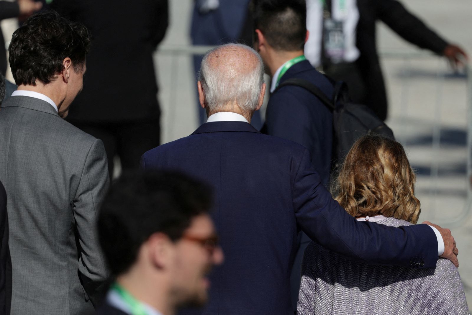 U.S. President Joe Biden and Italy's Prime Minister Giorgia Meloni embrace next to Canada's Prime Minister Justin Trudeau as they were late to join for a group photo at the G20 summit, in Rio de Janeiro, Brazil, November 18, 2024. REUTERS/Ricardo Moraes REFILE - CORRECTING INFORMATION FROM ''THEY JOIN FOR A GROUP PHOTO'' TO ''THEY WERE LATE TO JOIN''