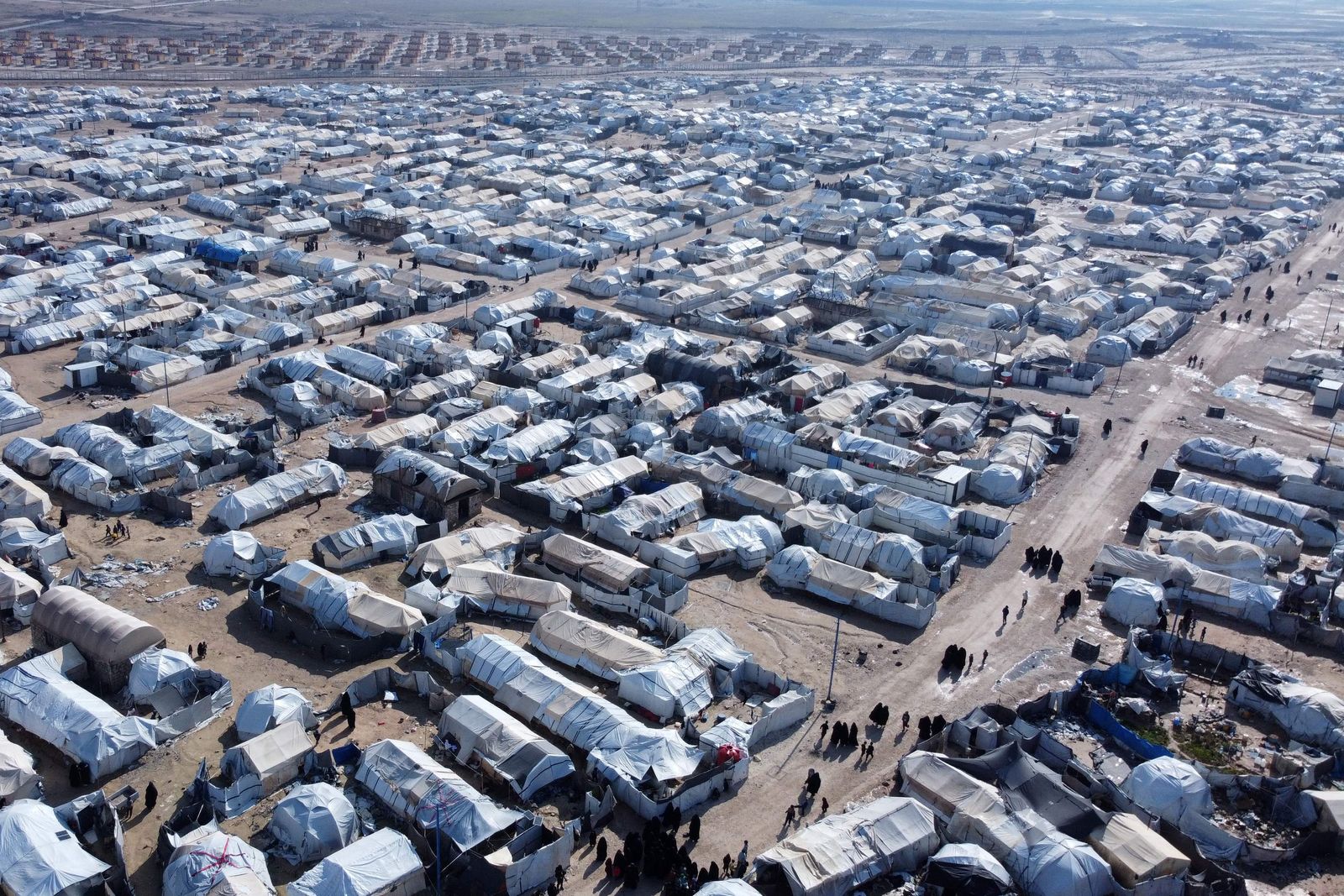 This aerial picture taken on January 27, 2024 shows a view of al-Hol camp in Syria's northeastern Al-Hasakah Governorate. The al-Hol camp is the largest of two in northeastern Syria holding the families of Islamic State fighters. Run by US-backed Kurdish-led Syrian Democratic Forces (SDF), its population spiked at more than 70,000 as the coalition began tightening its grip on the last IS holdout in Baghouz late in 2018. (Photo by Delil SOULEIMAN / AFP)