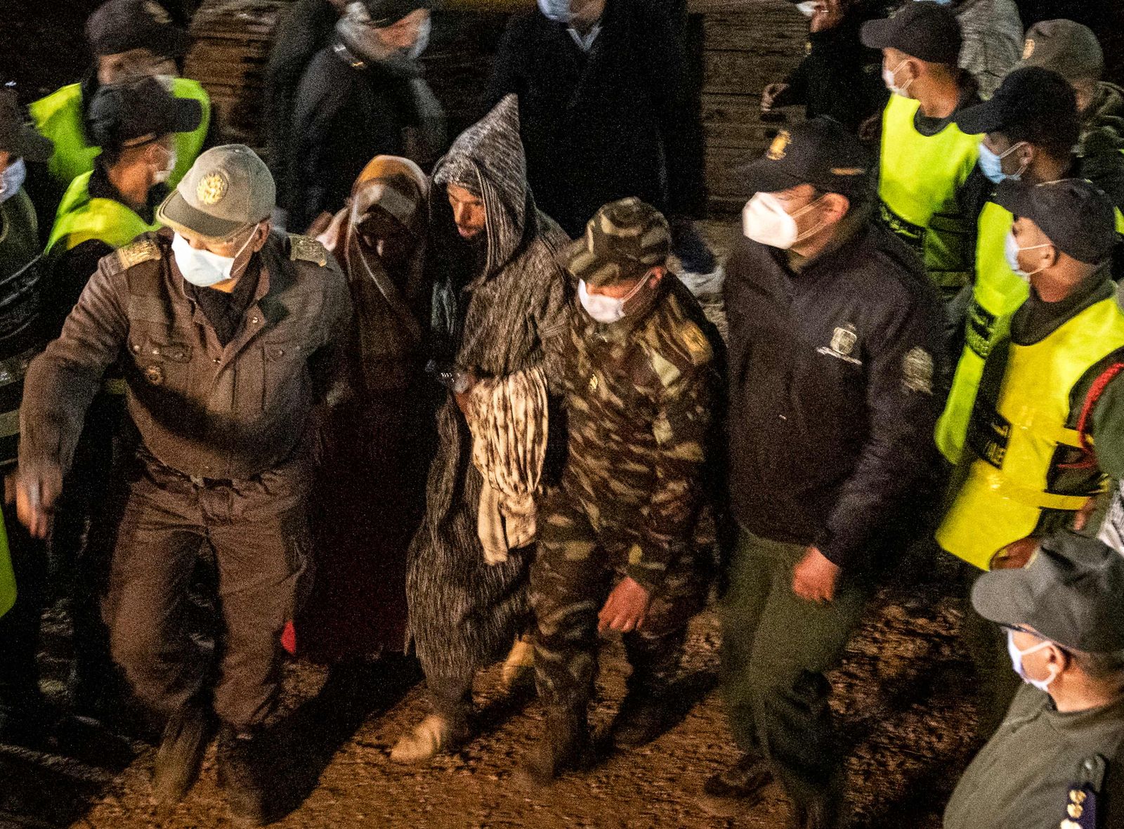 The parents of five-year-old Rayan Oram arrive at the scene where rescue teams try to remove the boy from a well shaft into which he fell into on February 1, in the remote village of Ighrane in the rural northern province of Chefchaouen, late on February 5, 2022. - Moroccan rescue crews found the five-year-old boy dead at the bottom of a well late on February 5, in a tragic end to a painstaking five-day operation that has gripped the nation. (Photo by Fadel SENNA / AFP) - AFP