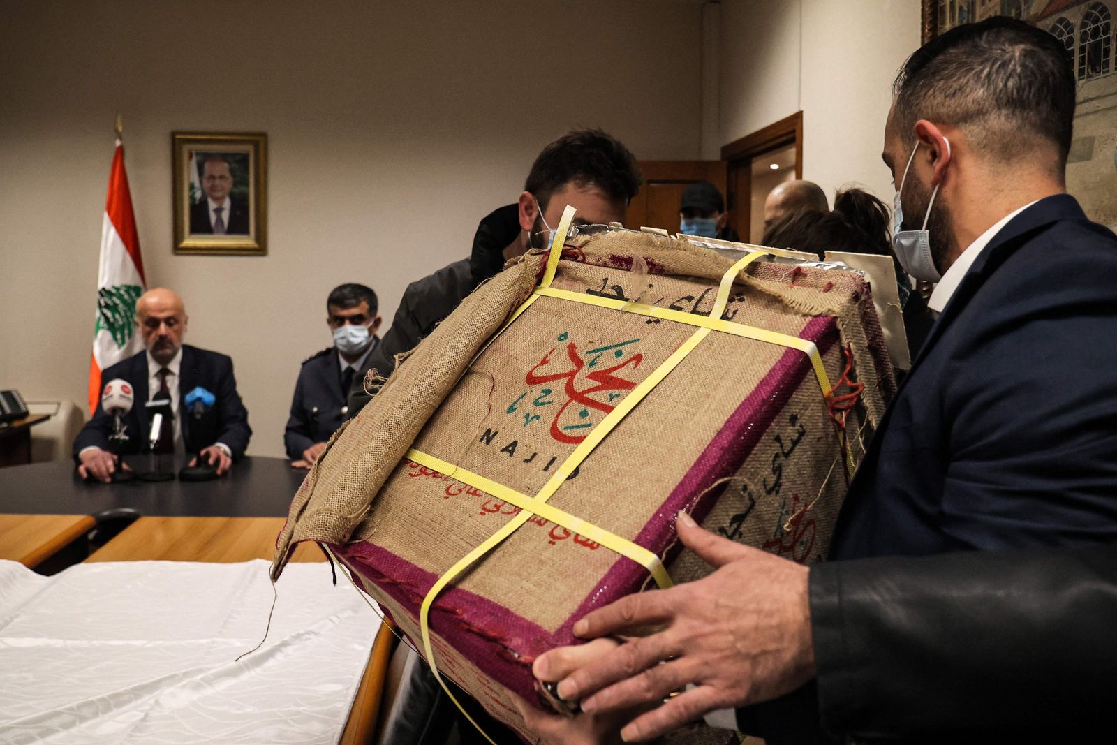 Lebanon's Interior Minister Bassam Mawlawi (L) gives a press conference about a seizure of a cache of captagon tablets, a codrug of amphetamine and theophylline, that was hidden in tea boxes to be smuggled, at the headquarters of the Internal Security Forces in Lebanon's capital Beirut on January 25, 2022. (Photo by ANWAR AMRO / AFP) - AFP