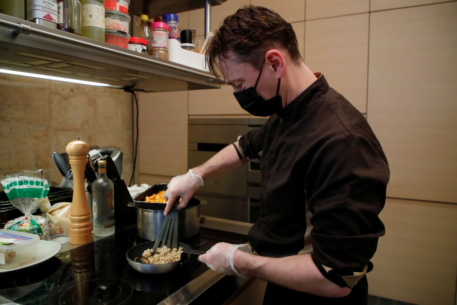 يحضر الطاهي الفرنسي لوران فيت طبقًا من ديدان الوجبة المقلية في مطعمه الذي يقدم طعامًا قائمًا على الحشرات فقط في باريس. - REUTERS