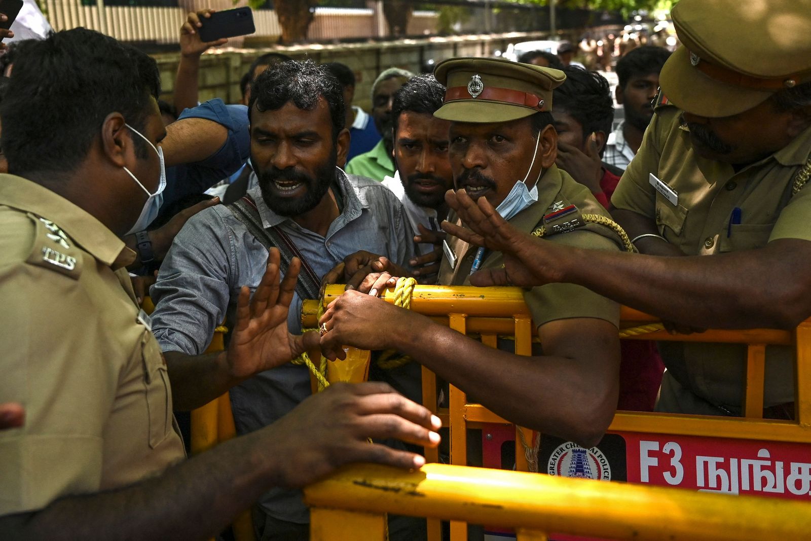 Police detain activists from Democratic Youth Federation of India (DYFI) during a protest against the government's new 'Agnipath' recruitment scheme for the army, navy, and air forces, in Chennai on June 20, 2022. (Photo by Arun SANKAR / AFP) - AFP