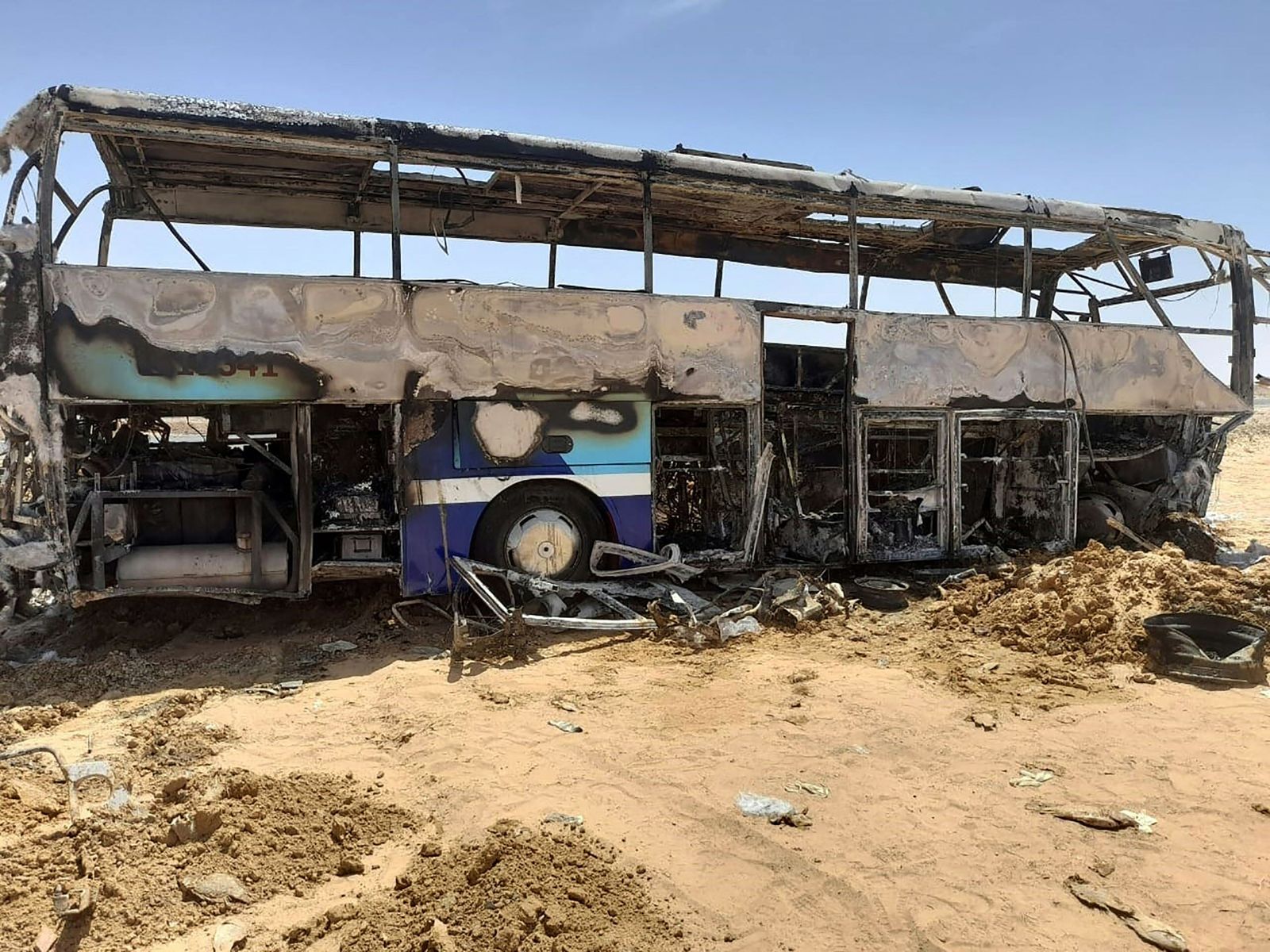 A picture shows the scene of a bus accident which occurred in early hours of April 13, 2022 when the vehicle collided with a car as it was transporting tourists on a road between Aswan and the famed Abu Simbel temple further south. - Ten people, including five Egyptians, four French and one Belgian tourist were killed in the bus crash in southern Egypt, the governor of Aswan said. Fourteen others -- eight French and six Belgians -- were taken to hospital with 