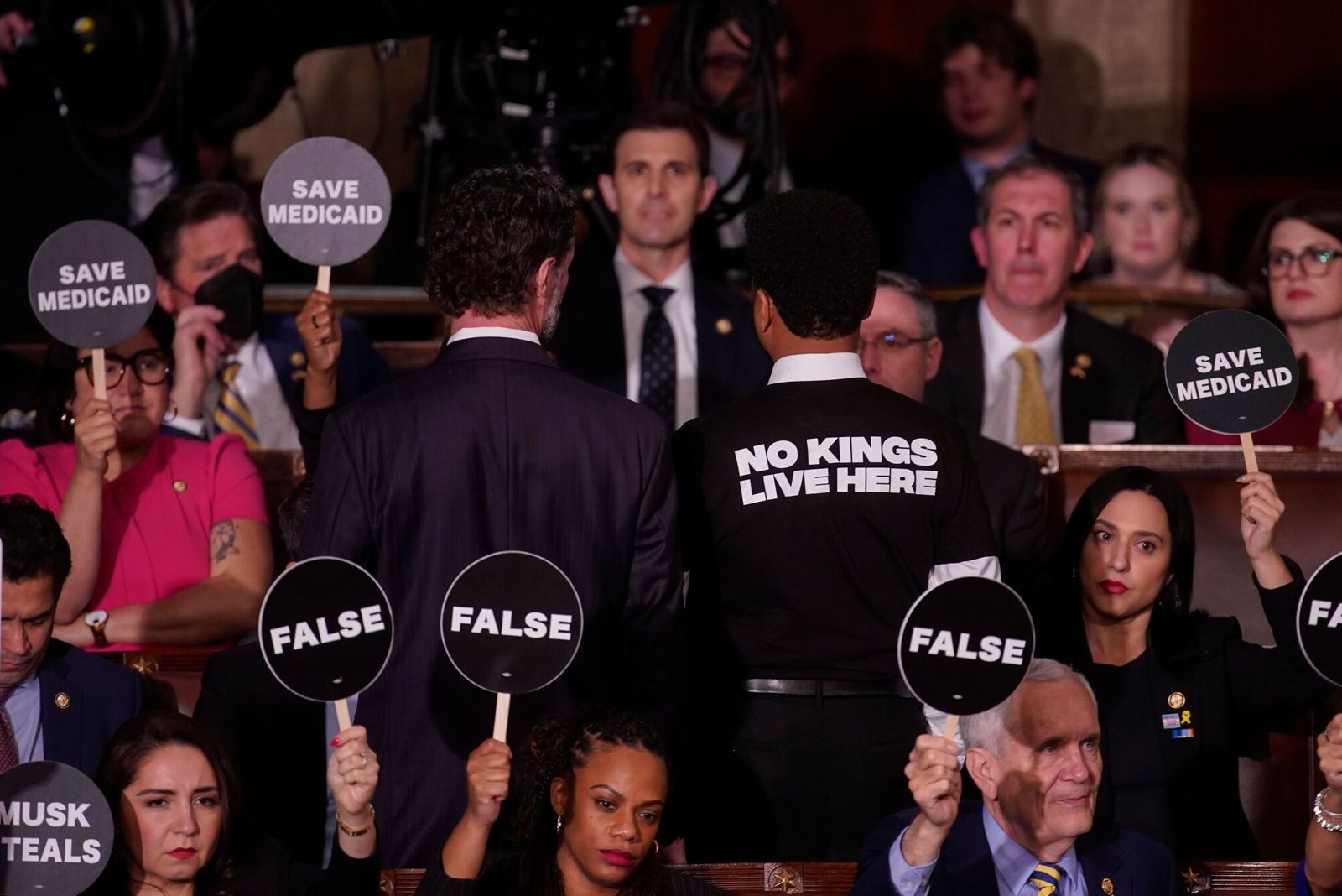 House Democrats hold signs in protest during a joint session of Congress in the House Chamber of the US Capitol in Washington, DC, US, on Tuesday, March 4, 2025. Donald Trump's primetime address Tuesday night from Capitol Hill, billed as a chronicle of his 'Renewal of the American Dream,' comes at a critical juncture early in his second term, as voters who elected him to tackle inflation and improve the economy are beginning to weigh the impact of his agenda. Photographer: Al Drago/Bloomberg