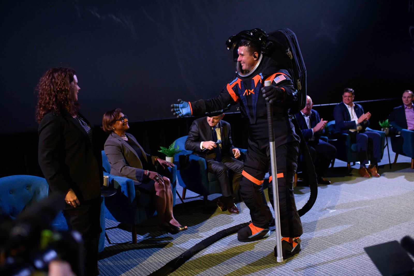 Chief Engineer Jim Stein goes to hug to NASA�s Lara Kearney while wearing the new spacesuit during the Axiom Space Artemis III Lunar Spacesuit event at Space Center Houston in Houston, Texas, on March 15, 2023. - 