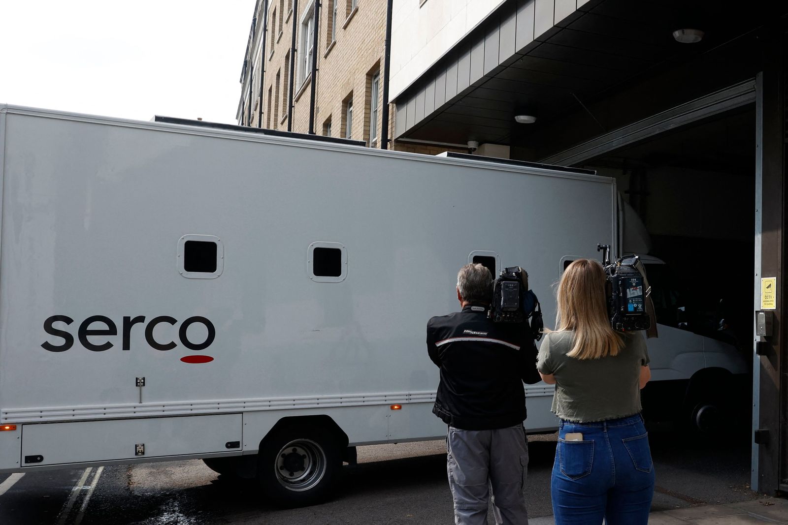 Journalists film a van believed to be transporting Jaswant Singh Chail arriving at the Westminster Magistrates' Court, in London, on August 17, 2022, in order to appear for an hearing, following his arrest while armed with a crossbow at Windsor Castle as Queen Elizabeth II spent Christmas Day there. - Police charged the 20-year-old man with an offence under Britain's 1842 Treason Act after arresting. Jaswant Singh Chail, from Southampton in southern England, has also been charged with making threats to kill and possession of an offensive weapon following the incident at the castle, southwest of London, last year. (Photo by CARLOS JASSO / AFP) - AFP