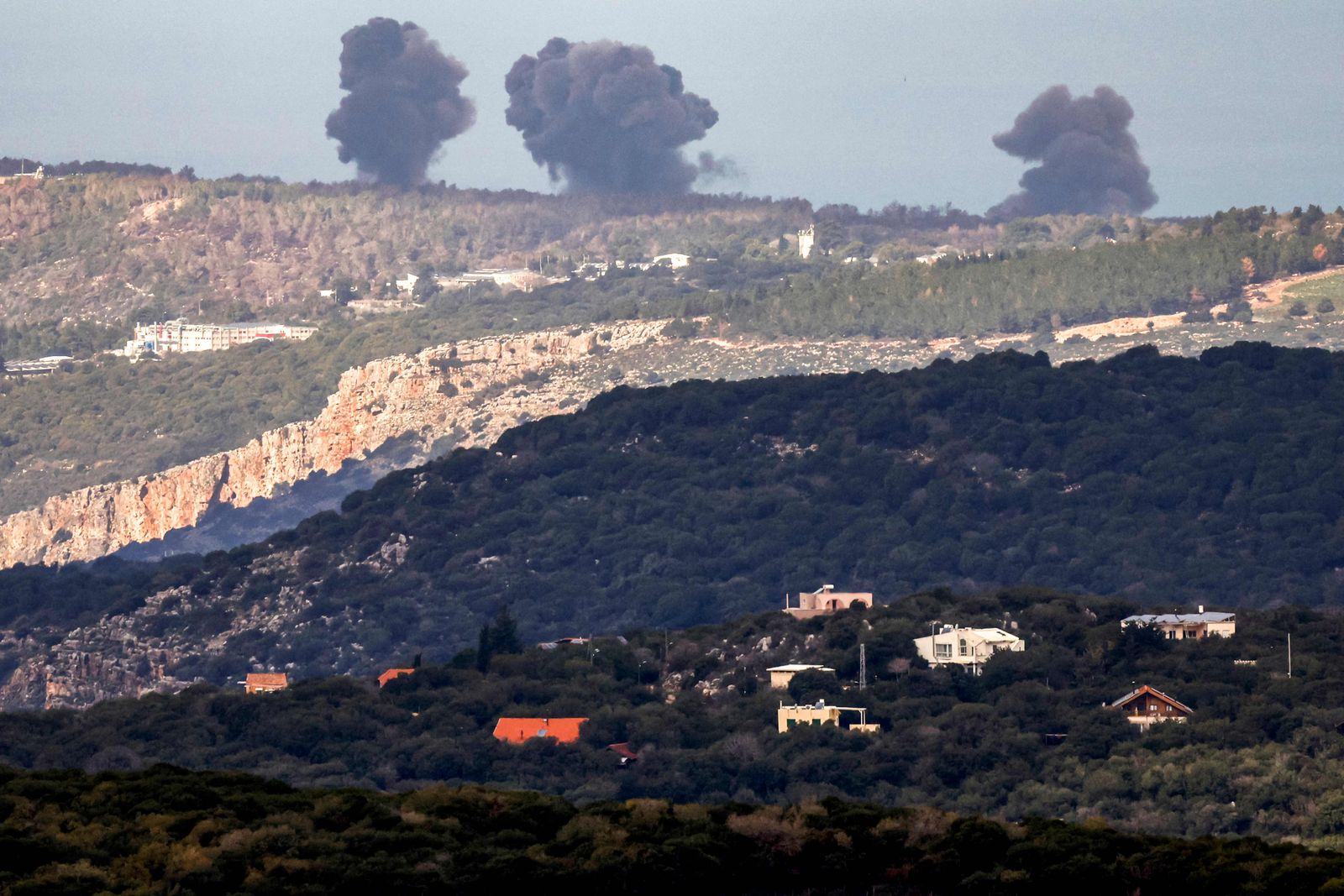 Smoke billows across the horizon along the hills in the Naqura area of southern Lebanon following Israeli bombardment from a position along the border in northern Israel on December 24, 2023. (Photo by Jalaa MAREY / AFP)