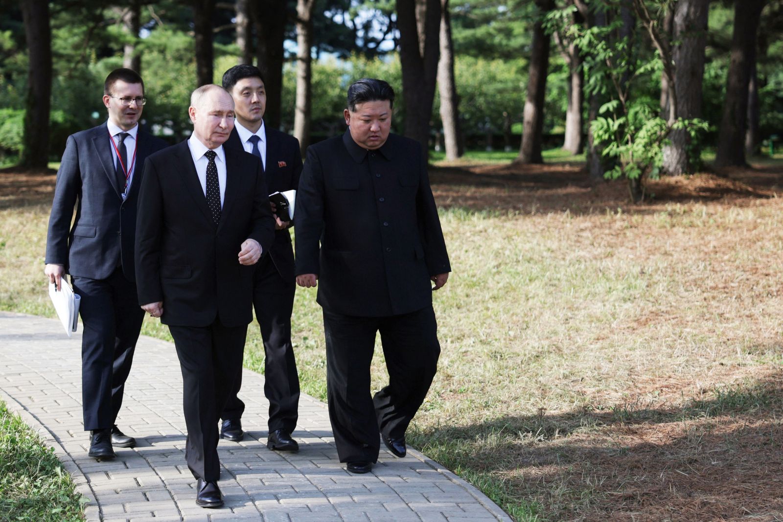 In this pool photograph distributed by the Russian state agency Sputnik, Russian President Vladimir Putin (2L) and North Korea's leader Kim Jong Un (R) walk during their meeting in Pyongyang, on June 19, 2024. Russian President Vladimir Putin signed a mutual defence agreement on June 19 with North Korea's Kim Jong Un, who offered his 'full support' on Ukraine. The pledge of military cooperation was part of a strategic treaty signed during a summit in Pyongyang, where Putin was making his first visit in 24 years. (Photo by Gavriil GRIGOROV / POOL / AFP) / -- Editor's note : this image is distributed by the Russian state owned agency Sputnik -