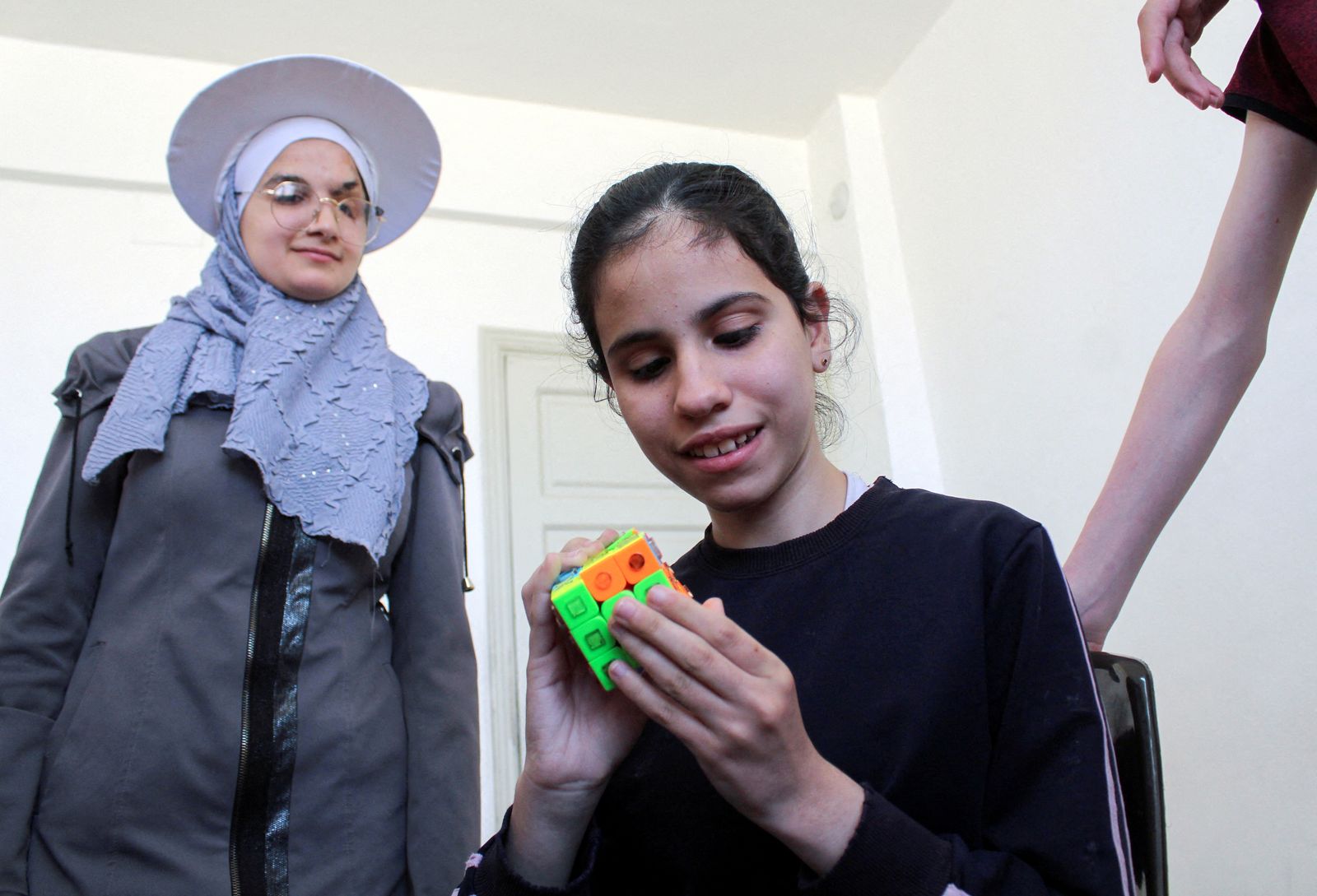 A visually impaired girl solves a Rubik's cube in Damascus