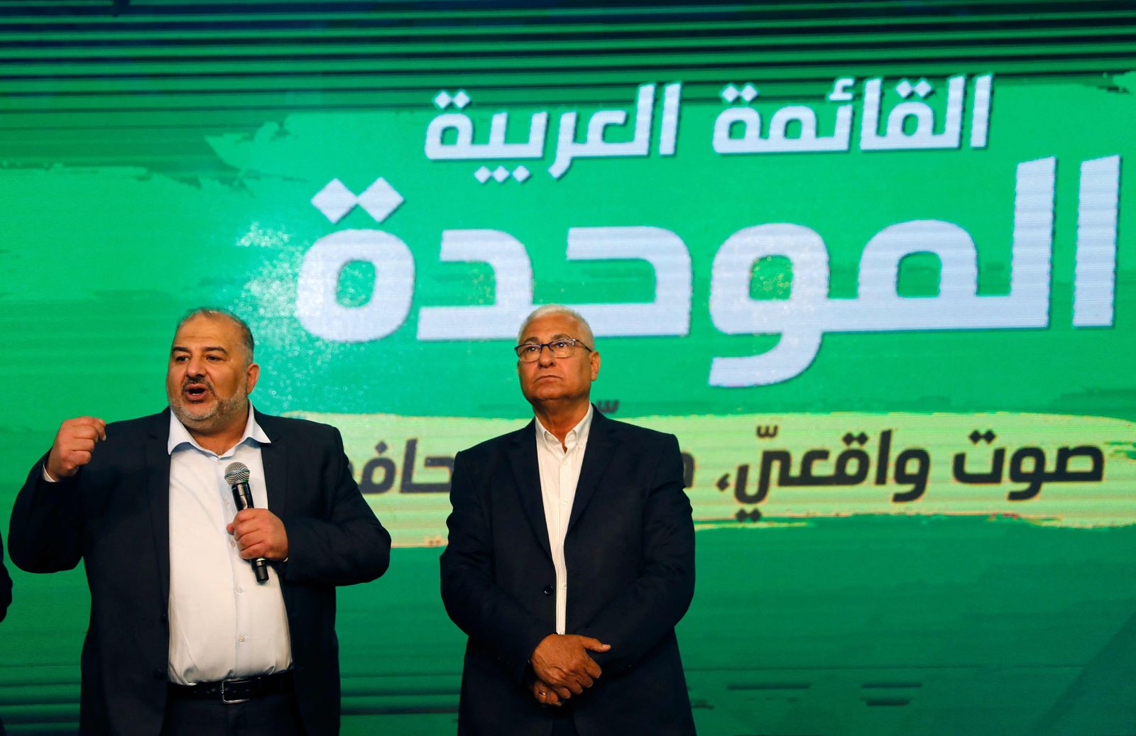 Mansour Abbas (L), leader of the United Arab List, speaks to supporters from his campaign headquarters in the northern Israeli city of Tamra on March 23, 2021, before polling stations close during the fourth Israeli national election in two years. (Photo by Ahmad GHARABLI / AFP) - AFP