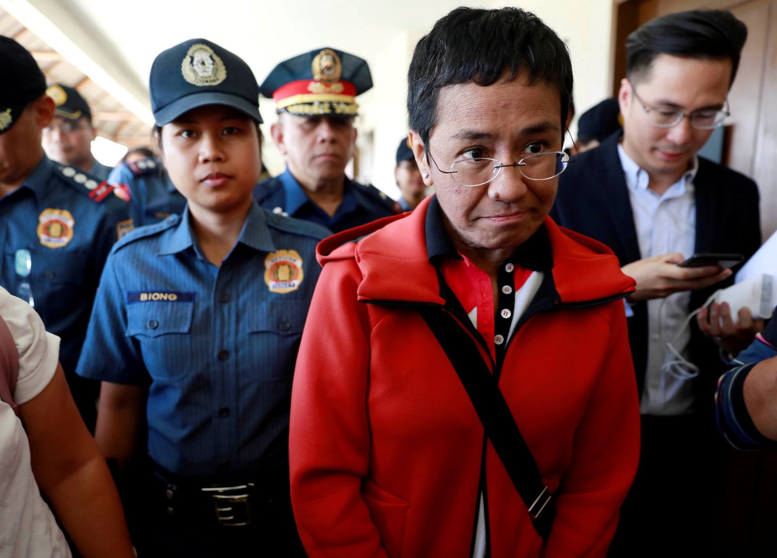 FILE PHOTO: Rappler CEO and Executive Editor Ressa is escorted by police after posting bail in Pasig Regional Trial Court in Pasig City - REUTERS