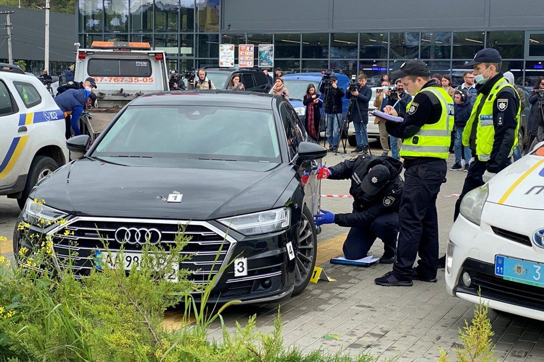 Investigators examine bullet holes in a car of presidential aide Serhiy Shefir following an assault outside Kyiv - REUTERS