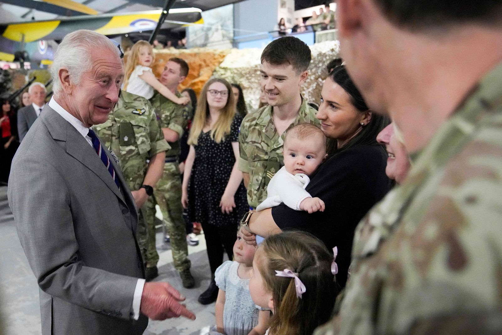 Britain's King Charles III (L) meets staff members and their families at the Army Aviation Centre in Middle Wallop, England, on May 13, 2024 as he arrives to attend a ceremony to officially hand over the role of Colonel-in-Chief of the Army Air Corps to his son Britain's Prince William, Prince of Wales. (Photo by Kin Cheung / POOL / AFP)