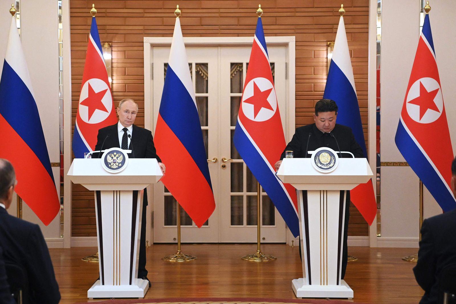 In this pool photograph distributed by the Russian state agency Sputnik, Russian President Vladimir Putin (L) and North Korea's leader Kim Jong Un talk to the media following their billaterial talks at Kumsusan state residence in Pyongyang on June 19, 2024. Russian President Vladimir Putin signed a mutual defence agreement on June 19 with North Korea's Kim Jong Un, who offered his 'full support' on Ukraine. The pledge of military cooperation was part of a strategic treaty signed during a summit in Pyongyang, where Putin was making his first visit in 24 years. (Photo by Kristina Kormilitsyna / POOL / AFP) / -- Editor's note : this image is distributed by the Russian state owned agency Sputnik -