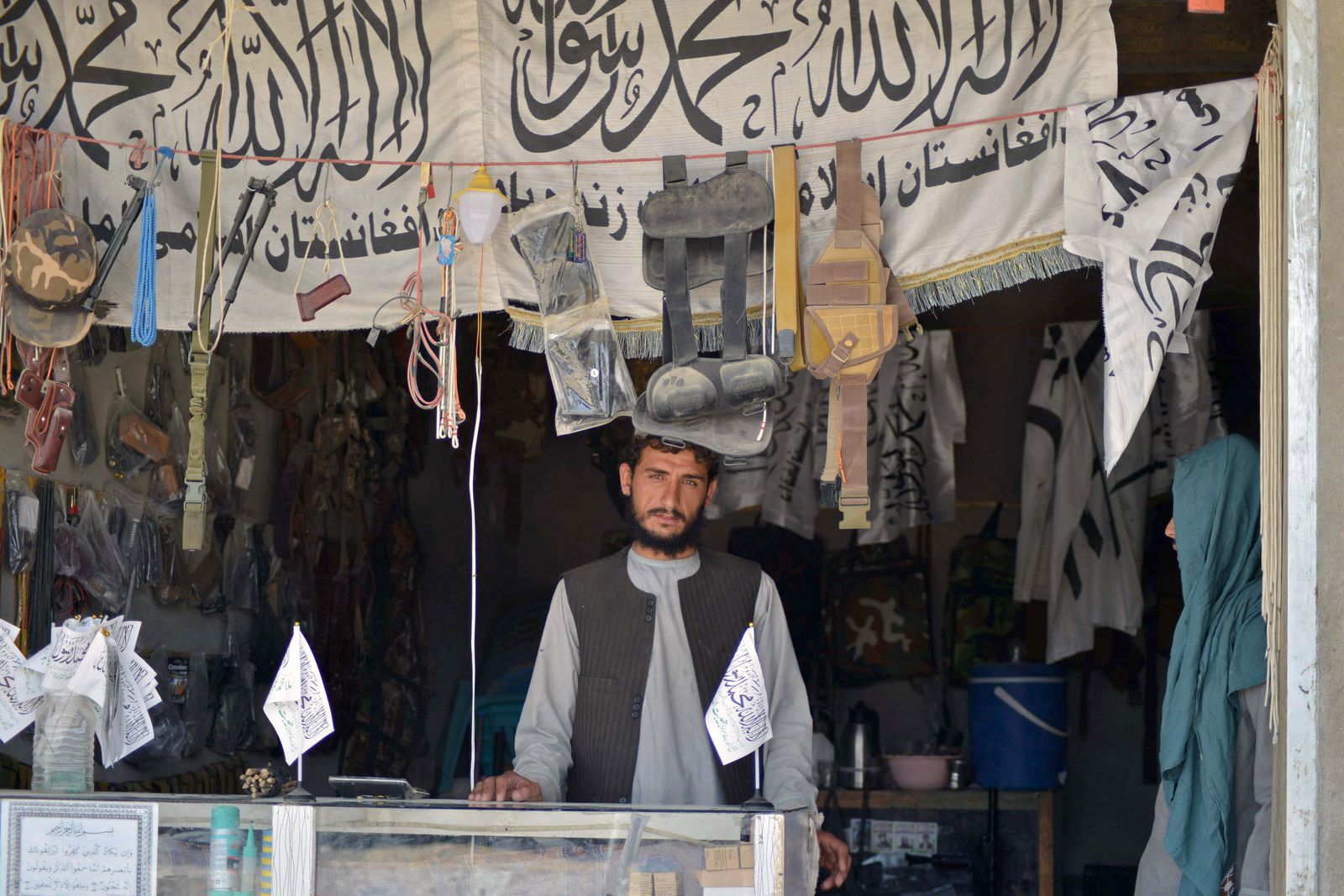 An Afghan vendor selling weapons and ammunition waits for customers in his shop at a market in Panjwai district of Kandahar province on September 4, 2021. (Photo by JAVED TANVEER / AFP) - AFP