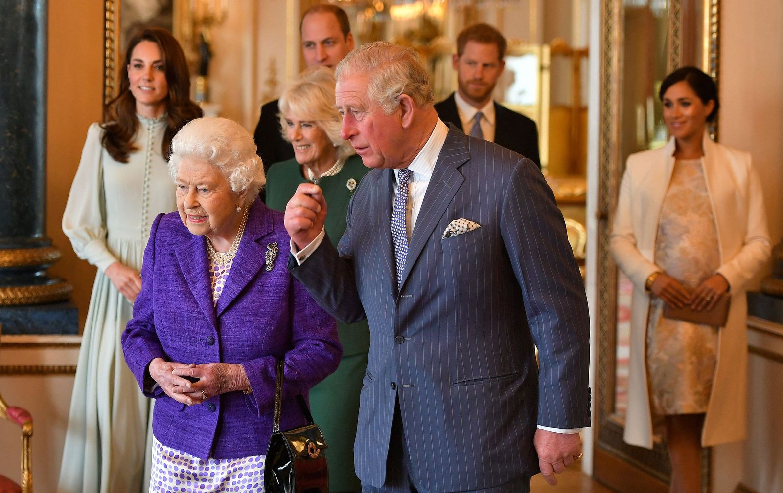 (FILES) In this file photo taken on March 05, 2019 Britain's Prince Charles, Prince of Wales (C) walks with his mother Britain's Queen Elizabeth II (2L), and his wife Britain's Camilla, Duchess of Cornwall (3L), and his sons and their wives, Britain's Prince William, Duke of Cambridge (4L) and Britain's Catherine, Duchess of Cambridge (L), and Britain's Prince Harry, Duke of Sussex, (2R) and Meghan, Duchess of Sussex (R) during a reception to mark the 50th Anniversary of the investiture of The Prince of Wales at Buckingham Palace in London. - Charles has spent virtually his entire life waiting to succeed his mother, Queen Elizabeth II, even as he took on more of her duties and responsibilities as she aged. But the late monarch's eldest son, 73, made the most of his record-breaking time as the longest-serving heir to the throne by forging his own path. (Photo by Dominic Lipinski / POOL / AFP) - AFP