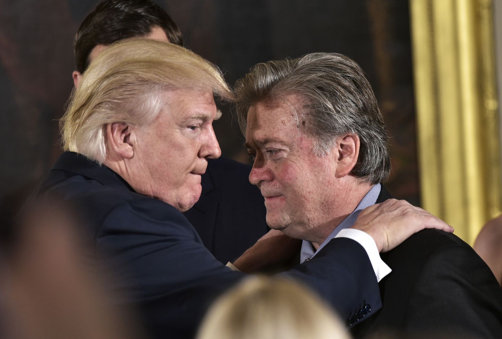 (FILES) In this file photo taken on January 22, 2017 US President Donald Trump (L) congratulates Senior Counselor to the President Stephen Bannon during the swearing-in of senior staff in the East Room of the White House in Washington, DC. - President Donald Trump has decided to pardon his influential former adviser Steve Bannon, US media reported January 19, 2021, though no official announcement had been made as Trump counted down his final hours in the White House. Bannon was granted clemency after being charged with defrauding people over funds raised to build the Mexico border wall that was a flagship Trump policy, the New York Times said citing White House officials. (Photo by MANDEL NGAN / AFP) - AFP