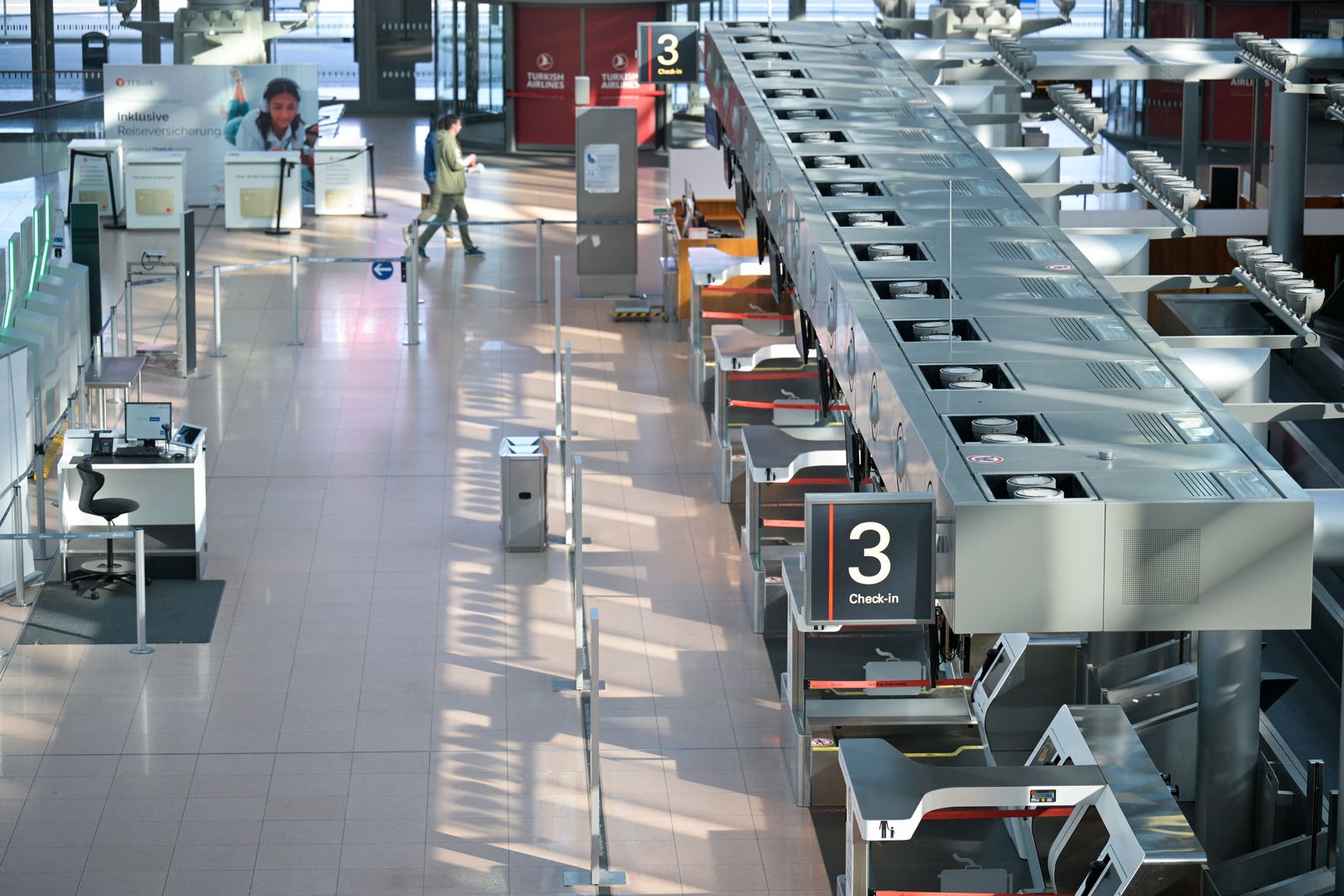 People walk in a hall of Hamburg airport, during an unexpected early strike affecting passengers, one day before a 24-hour strike at German airports called by the German trade union Verdi over a wage dispute, in Hamburg, Germany March 9, 2025. REUTERS/Fabian Bimmer