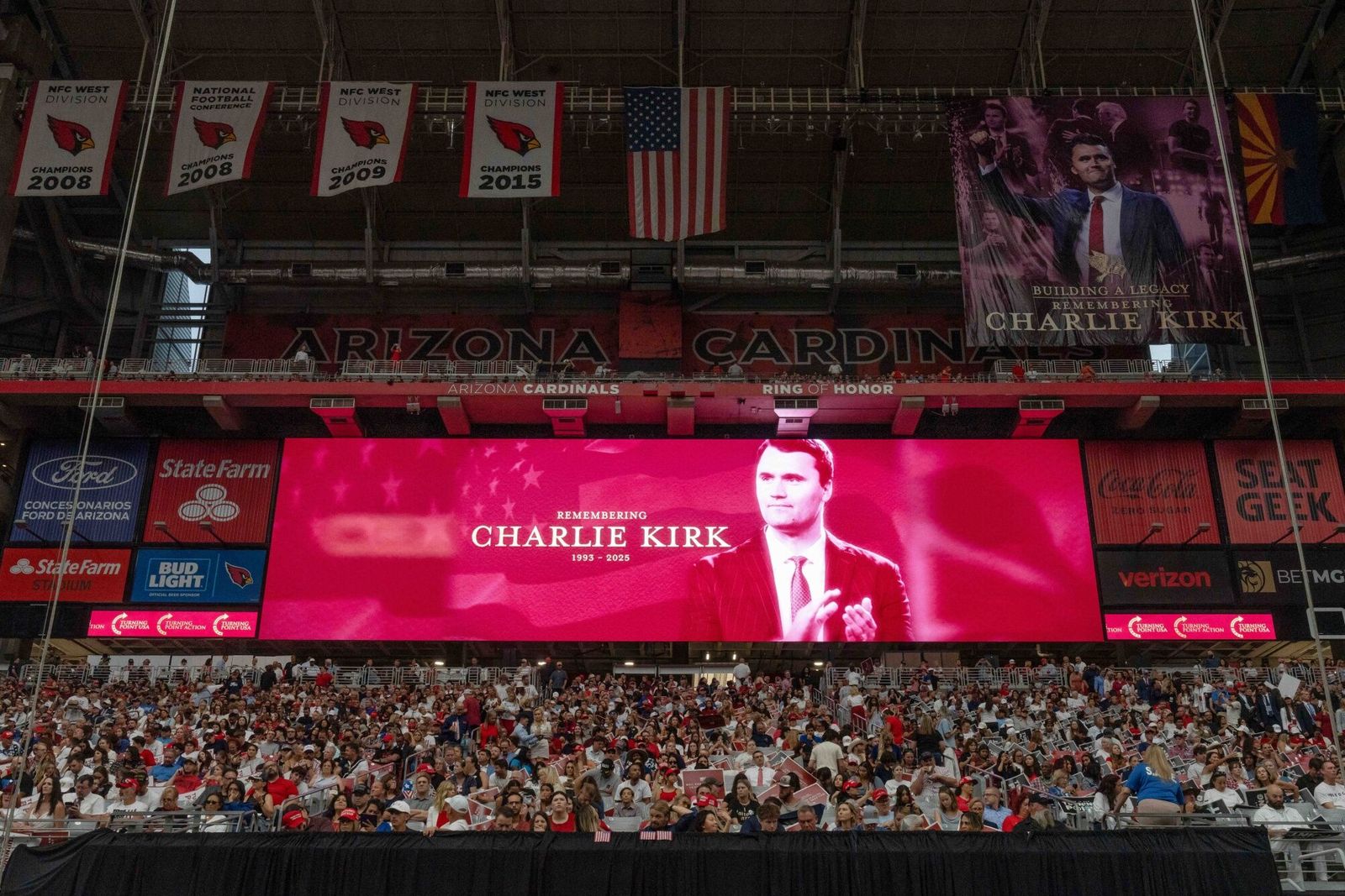 An image of Turning Point USA founder Charlie Kirk displayed ahead of a memorial service at State Farm Stadium in Glendale, Arizona, US, on Sunday, Sept. 21, 2025. President Donald Trump is set to eulogize Charlie Kirk as a patriot and Christian martyr on Sunday as the political activist's assassination continues to galvanize conservative support for the president. Photographer: Rebecca Noble/Bloomberg