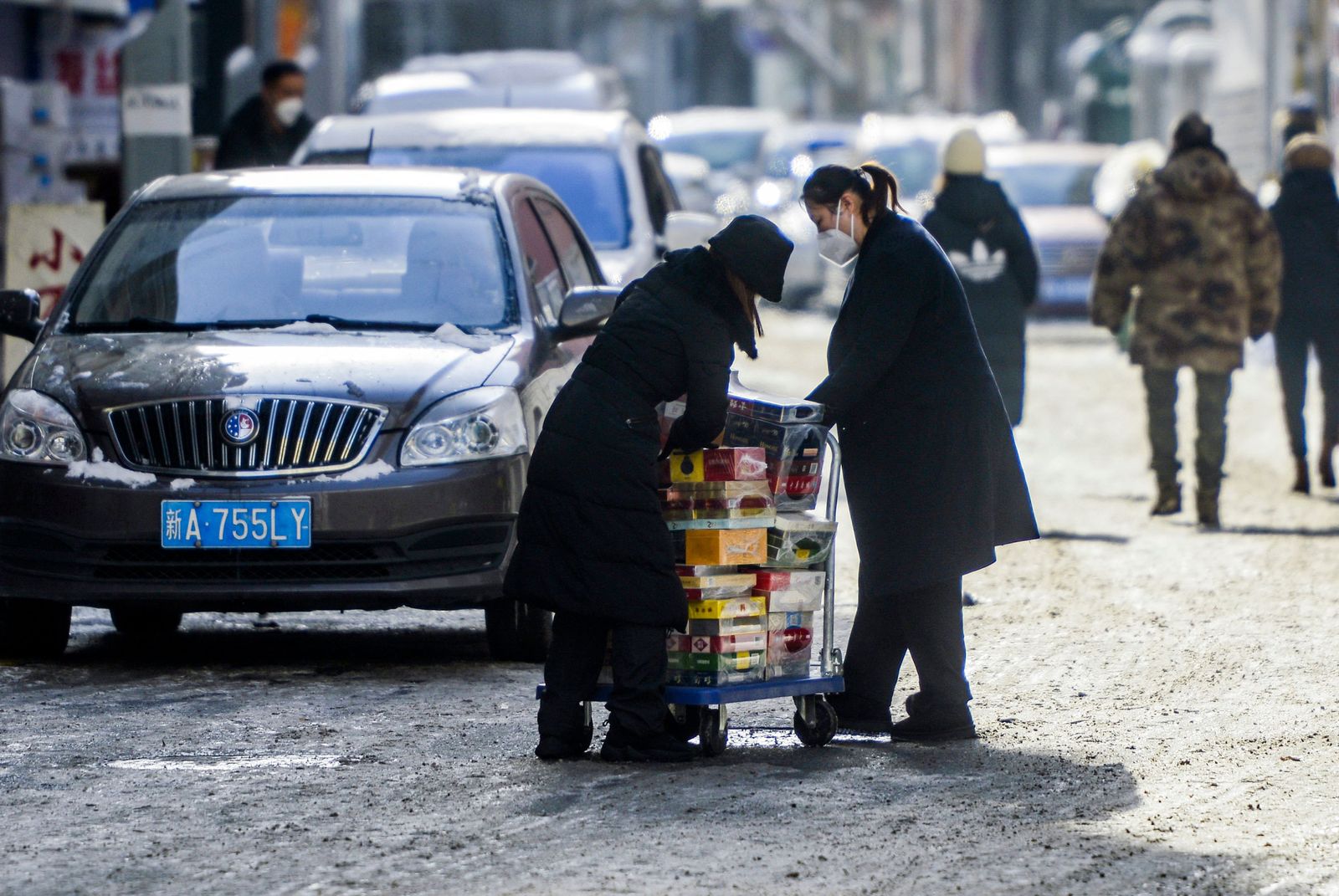 This photo taken on December 1, 2022 shows shop owners preparing items before reopening their store in Urumqi, in China's northwestern Xinjiang region, following the easing of Covid-19 restrictions in the city. (Photo by CNS / AFP) / China OUT - AFP